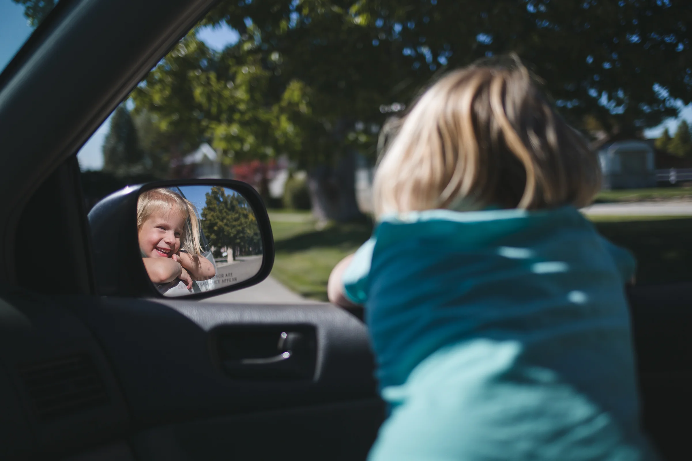 I was driving my Jane to her piano lesson, and Nora climbed in the front seat and hung her little self out the window. Since I couldn't drive anywhere, I took pictures. :)