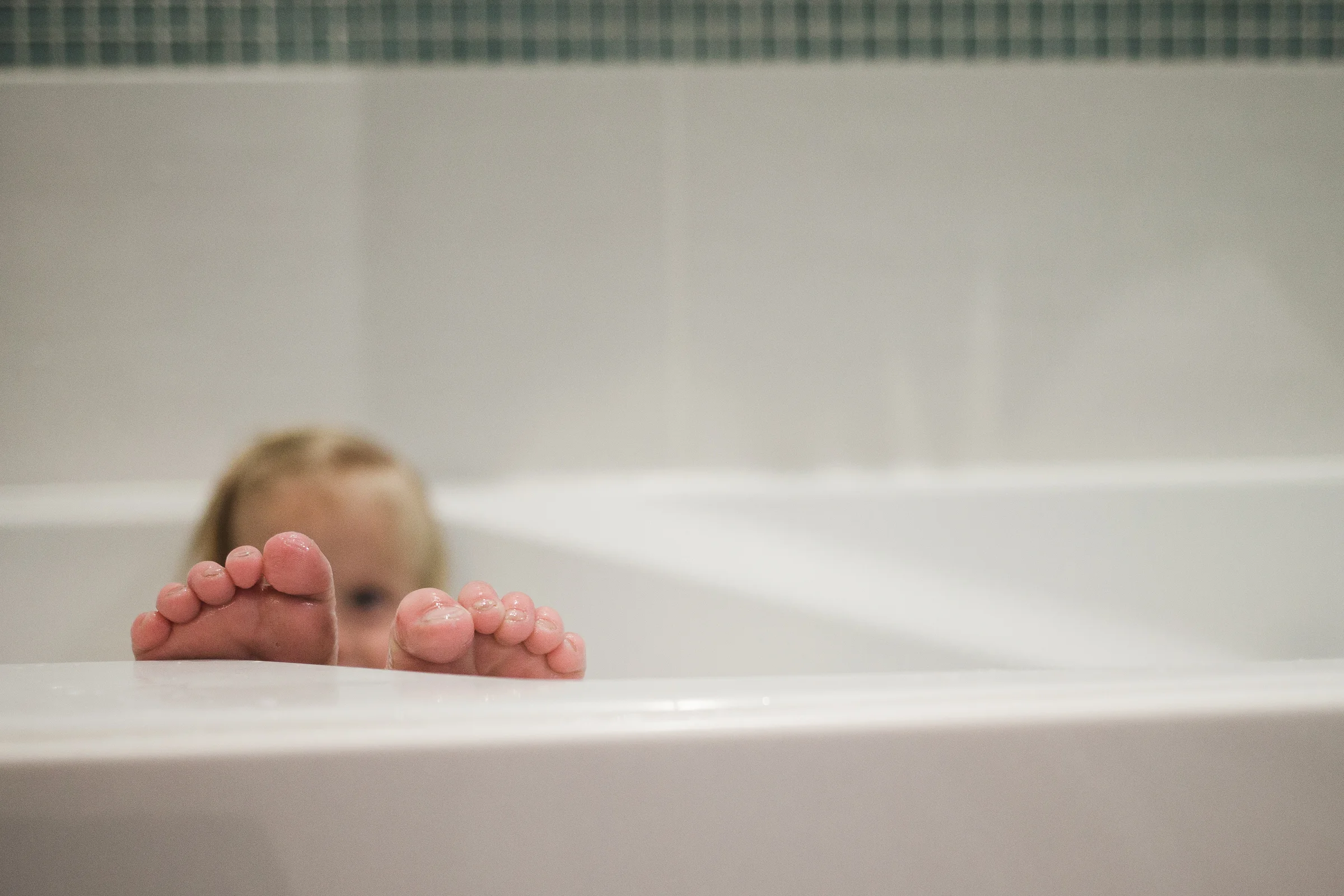 My Nora takes baths at all times of the day. And in my bath. Silly girl. She was playing peekaboo with her cute toes just then, so I grabbed the shot.