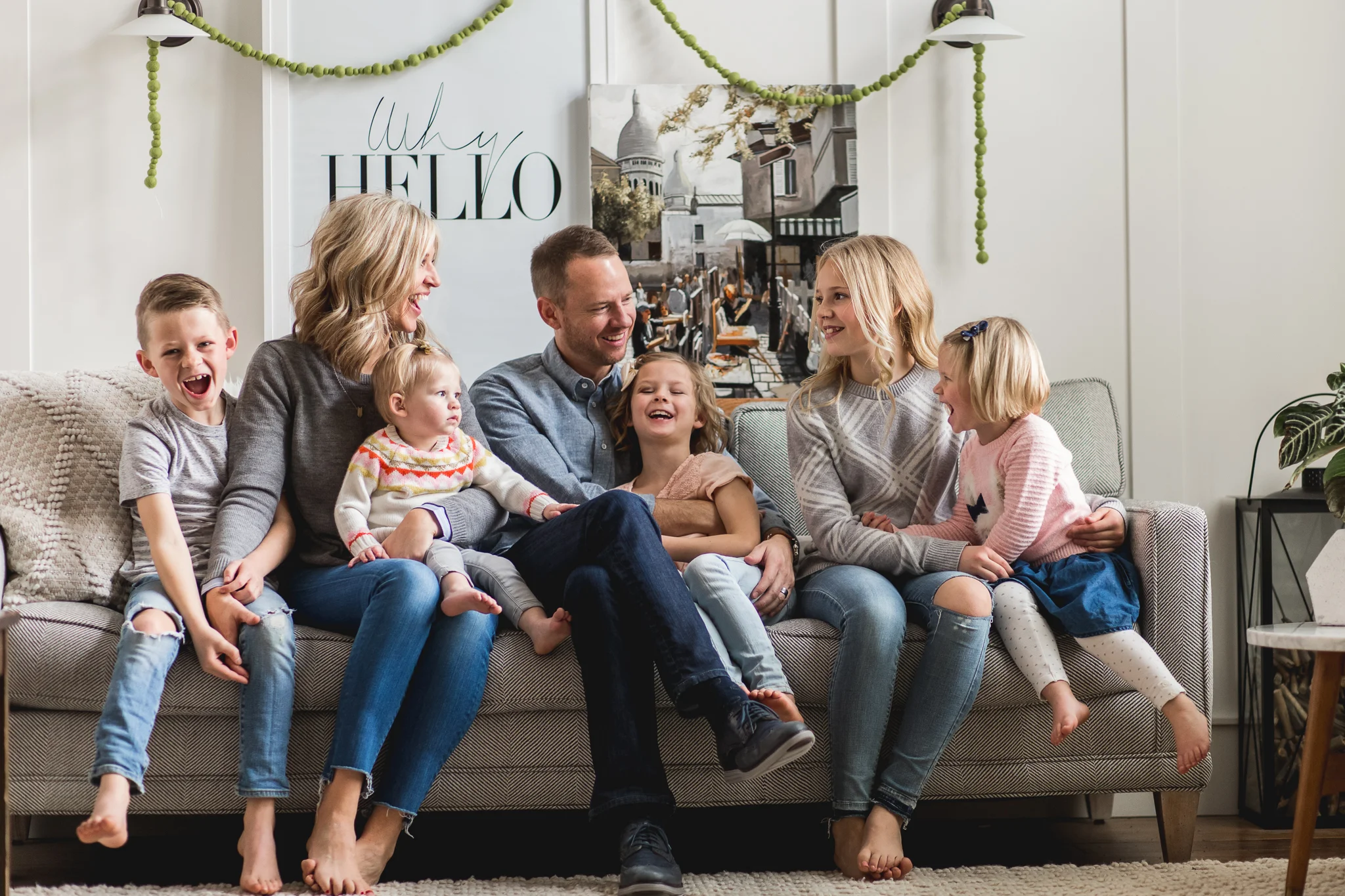 Family laughing on couch - Utah Lifestyle Family Photographer