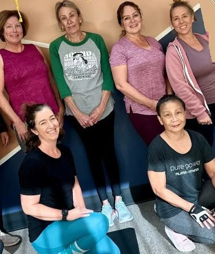 Smiling fitness class members at Pure Power Pilates + Fitness in San Diego