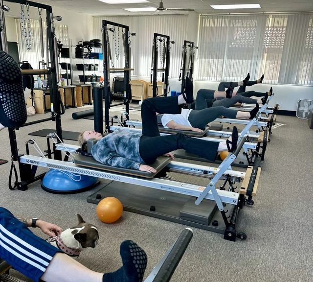 Clients on reformers during a P3 Pure Power Pilates class