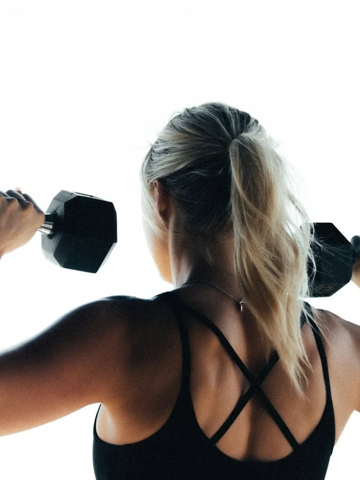 Woman strength training with dumbbells