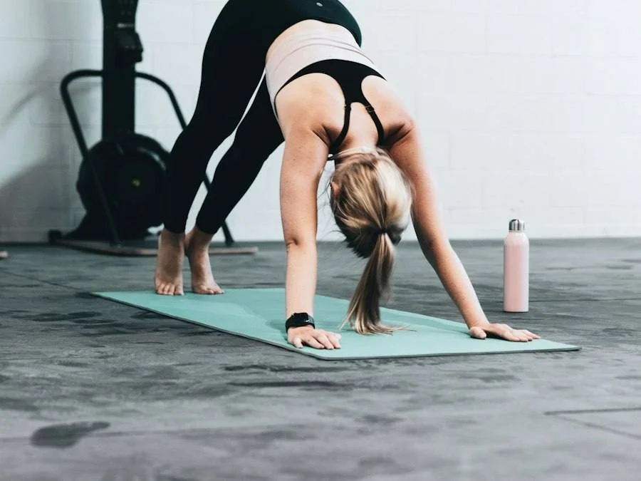 Woman in downward dog on a yoga mat