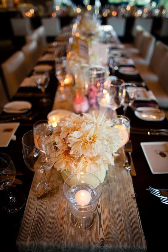 A Killer Centerpiece. You can never go wrong with the glam combo of florals + candles. For bold impact, place three to four vases of fresh cut flowers, staggered with a few lit votives. Super moody and an easy way to turn up the atmosphere.