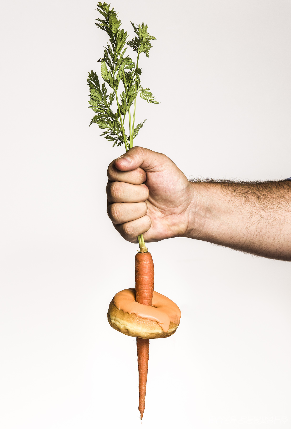 Concept image of the dynamics between eating healthy and draw of junk food. Studio lighting