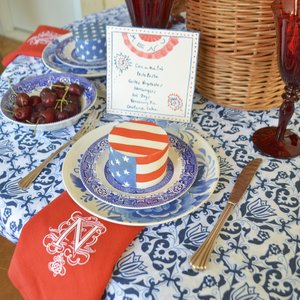 Mini Cake Wrapped in  Flag Chefanie Sheets , over  Blue &amp; White Tablecloth , with  Custom Embroidered Napkins