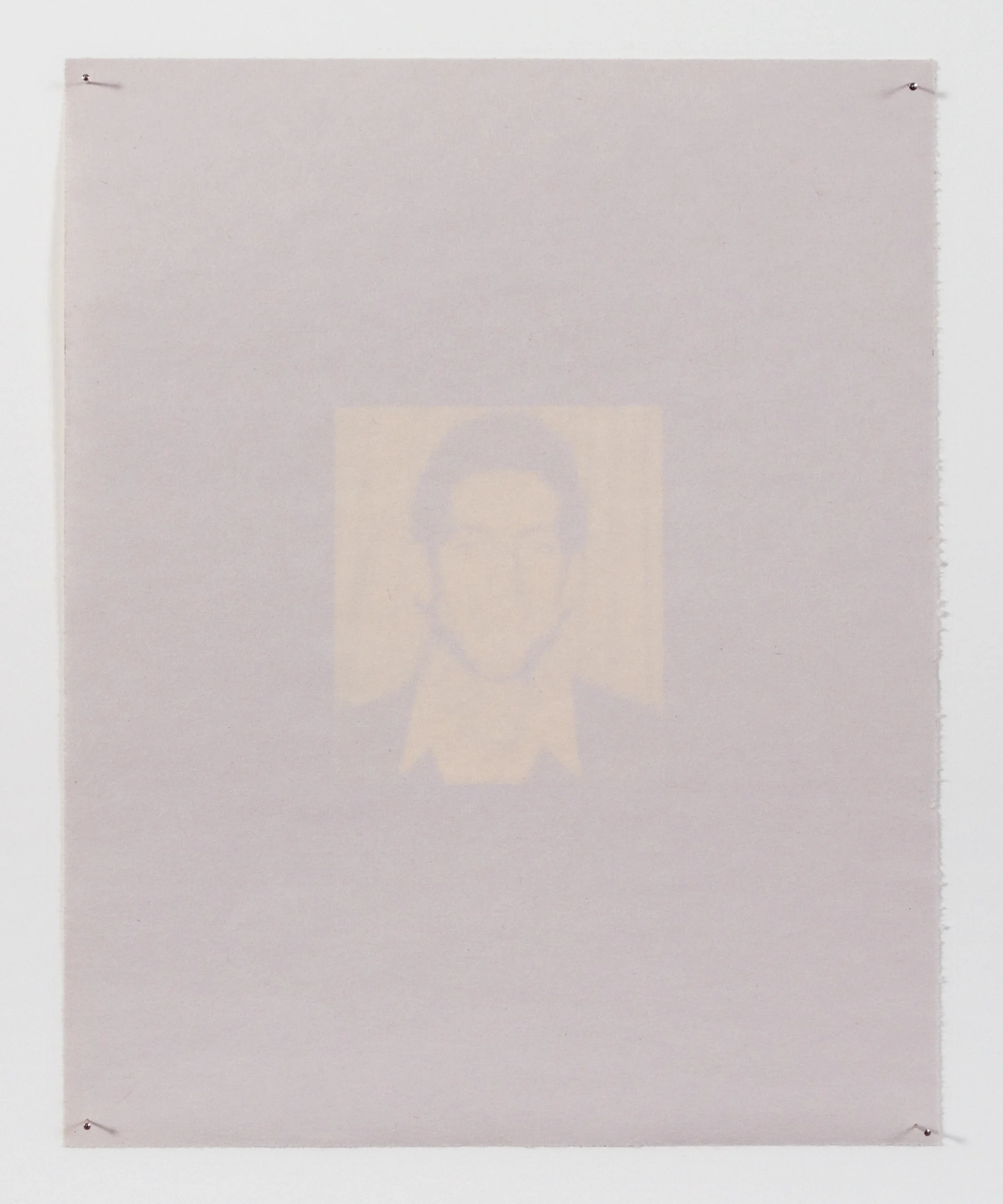 The head of the household appears on newsprint, slowly fading with continued exposure to the sun. 