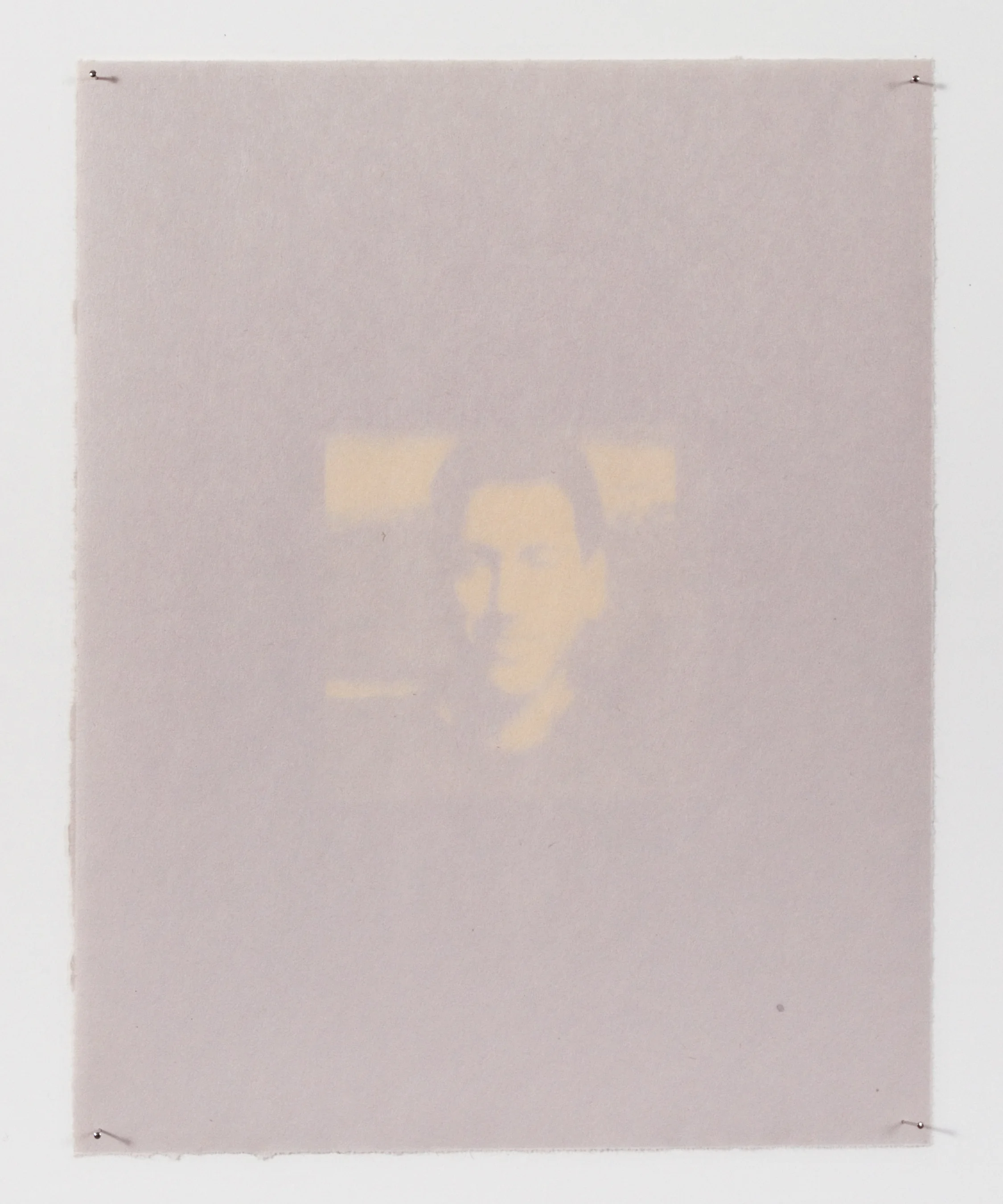 The head of the household appears on newsprint, slowly fading with continued exposure to the sun. 
