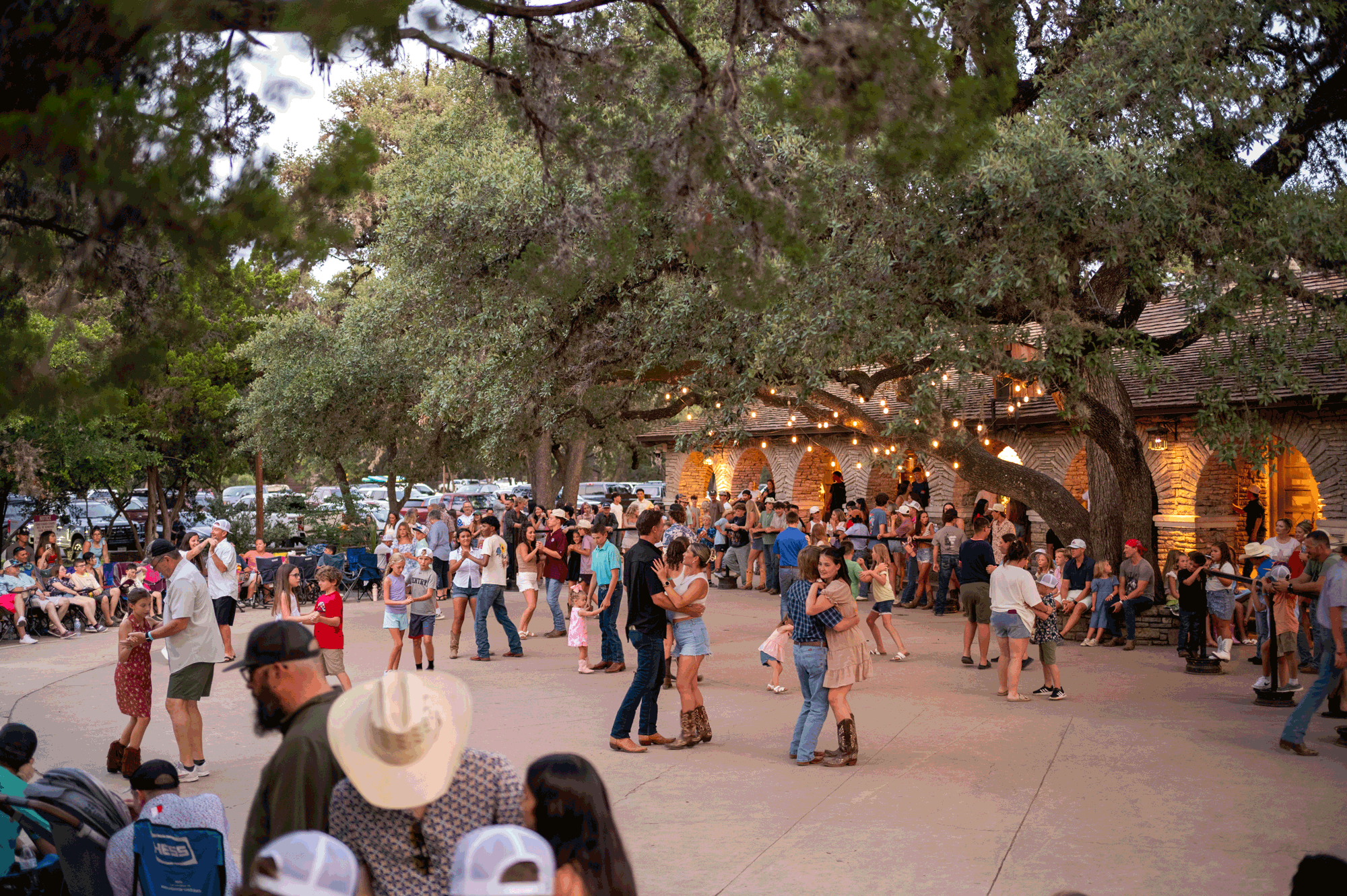 People of all ages dancing on the Pavillion at Garner State Park during a summer dance.