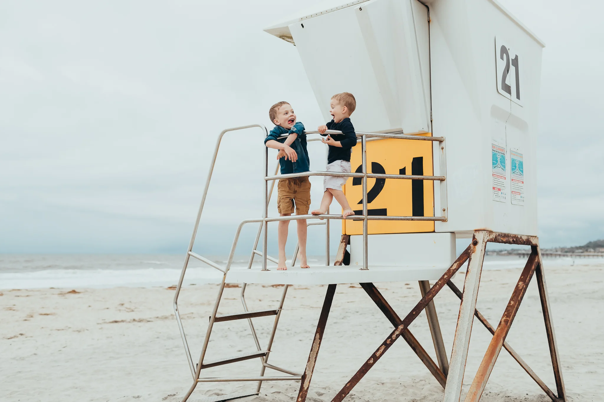 two brothers making silly faces on the beach
