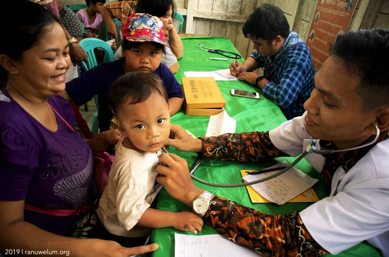 dr. Tiop Pasaribu and Adams Sophiano, volunteer doctors at free medical check-up in Talekoi Village