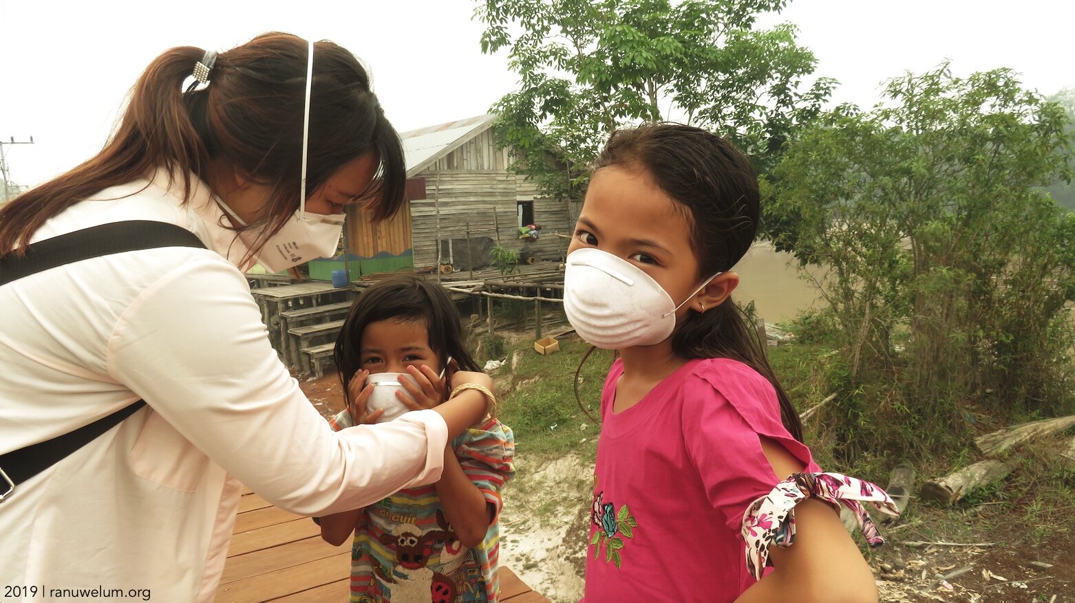 Ranu Welum staff Roro Ardya Garini with the children of Petuk Katimpun village.