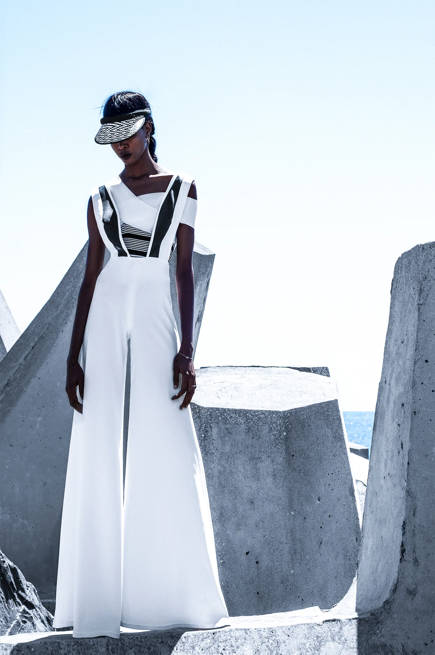 Stripe cropped top, stylist's own White jumpsuit with black latex insert, Ben Adams Gold hoop earrings and black-and-white peak cap, Woolworths