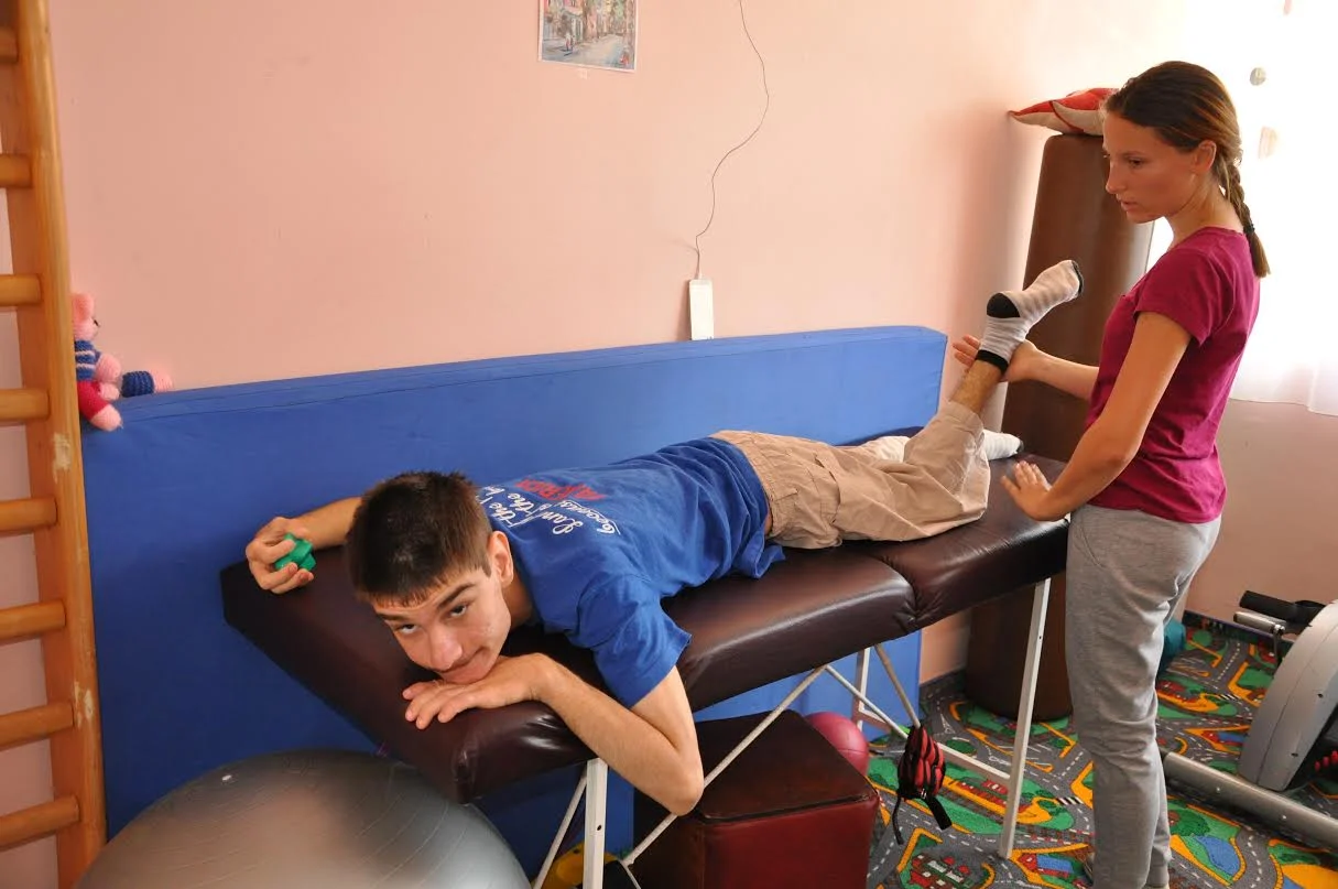 Picture taken by Marti Carroll during her recent visit. This is Natalia, one of RCE's physical therapists, working with Luci after his recent leg surgery.