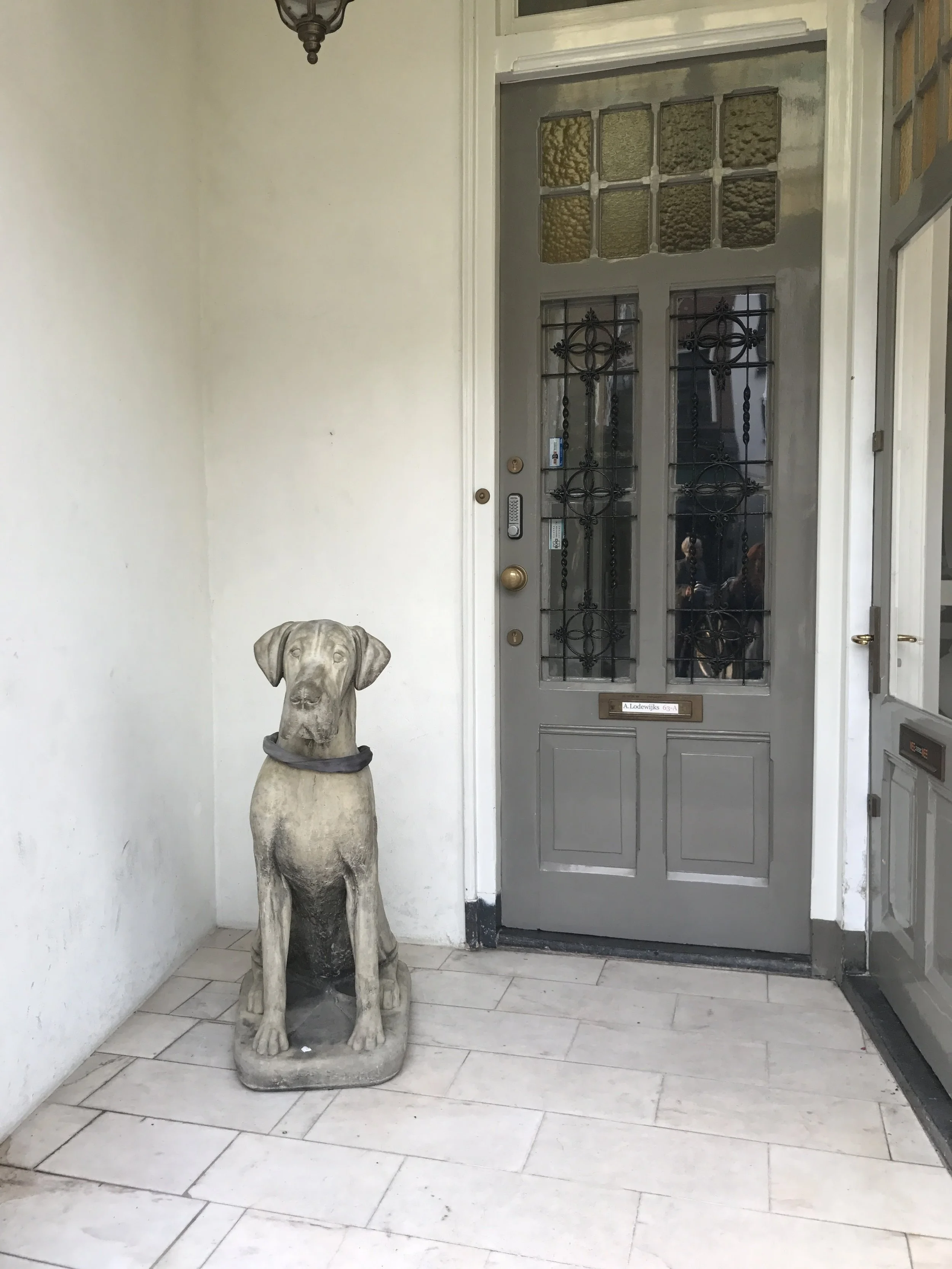 This lifesize stone Great Dane was chained to the wall.