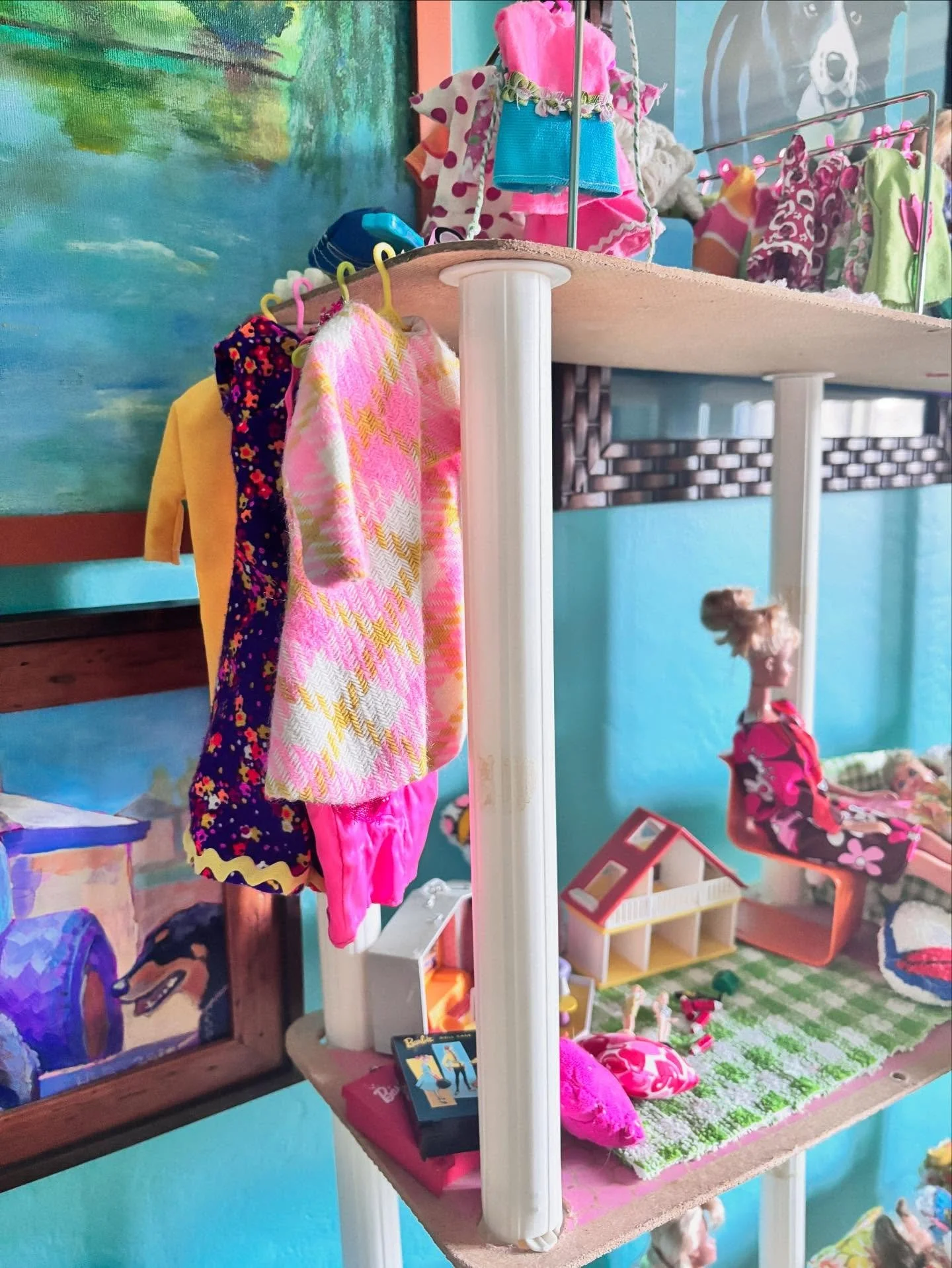 A colorful scene for a Monday morning. I took some time over the weekend to clean up the Barbie family townhouse. She doesn&rsquo;t have a closet (yet!) but she and I figured out a way to hang some of her favorite items, including this new vintage co