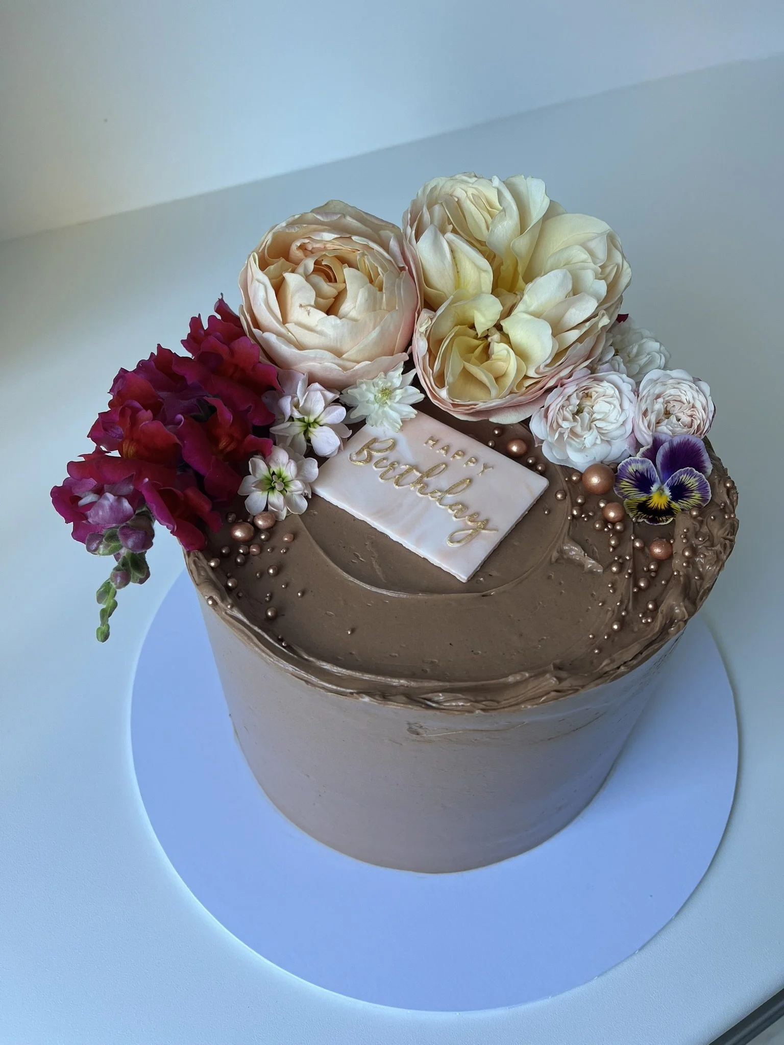 Chocolate cake with seasonal flowers