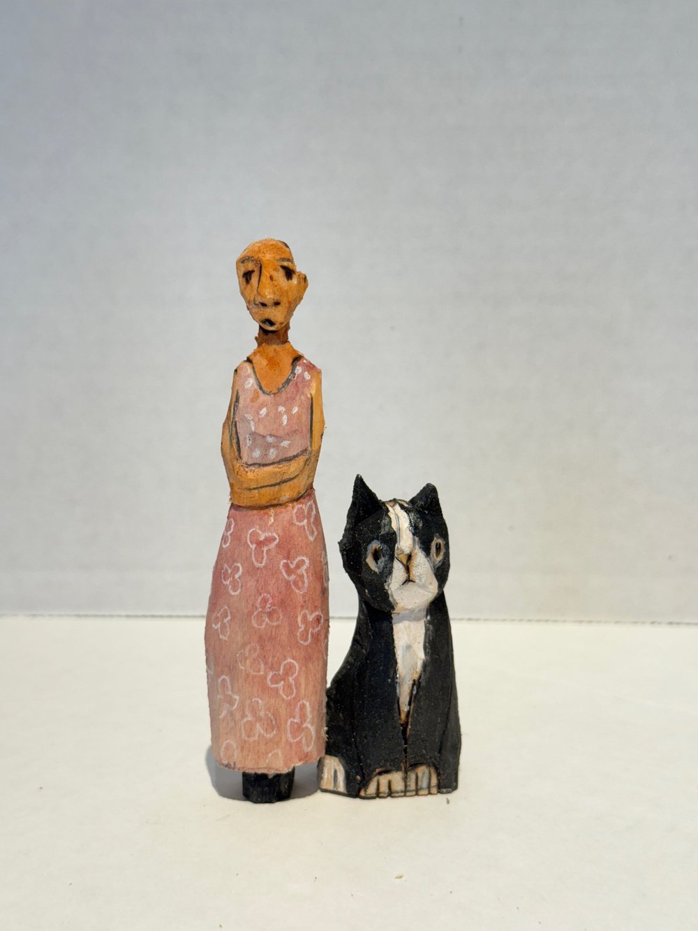 Woman in pink dress with black cat