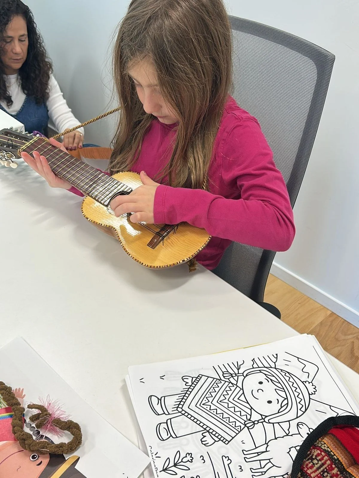 Isabella & Ferdinand student playing a charango in Spanish class