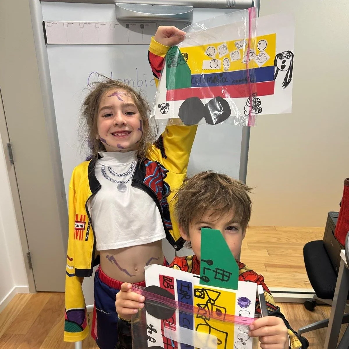 Isabella & Ferdinand students showing their Colombia flag crafts