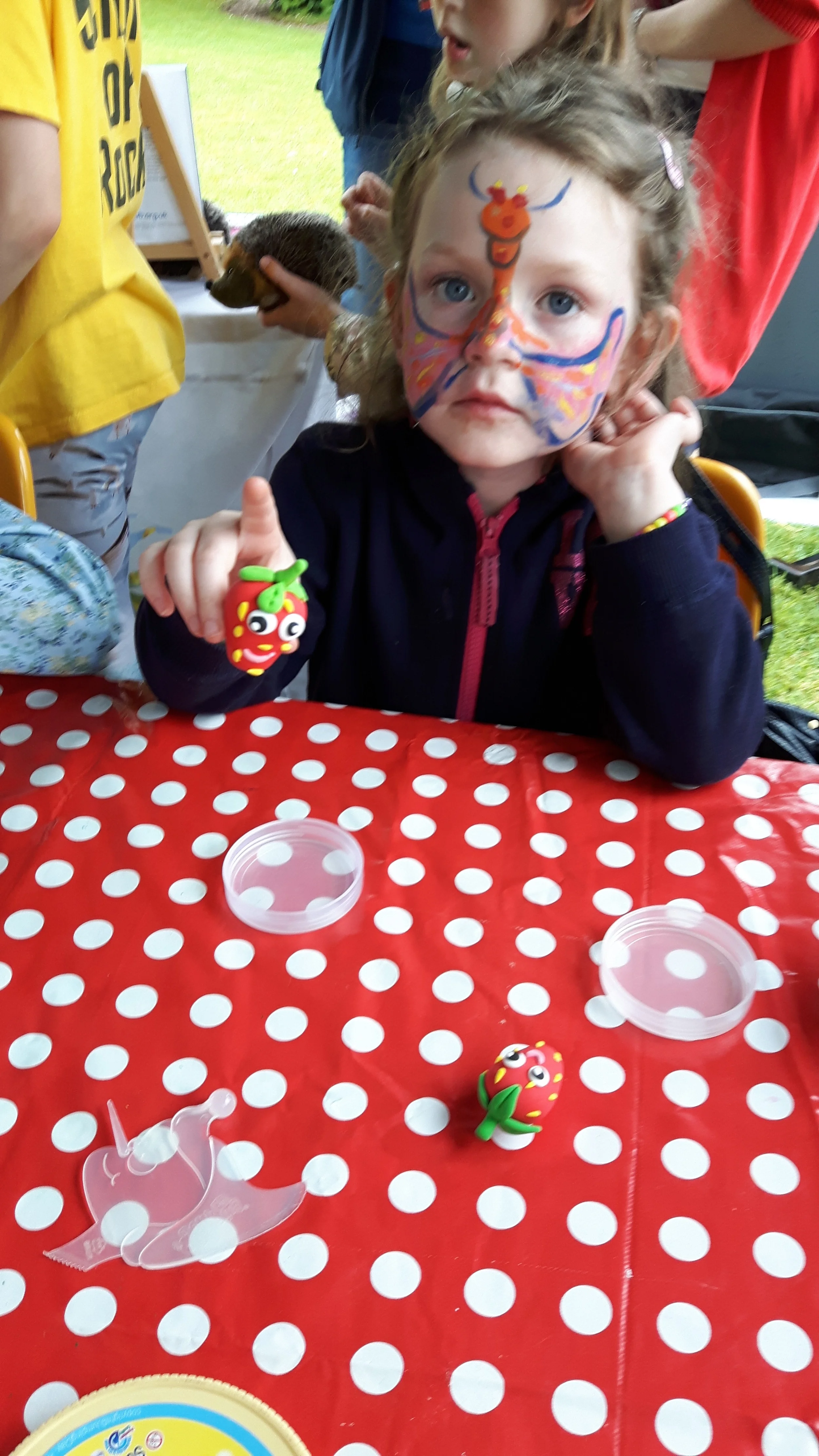 Strawberry magnet made with Jumping Clay and face painting