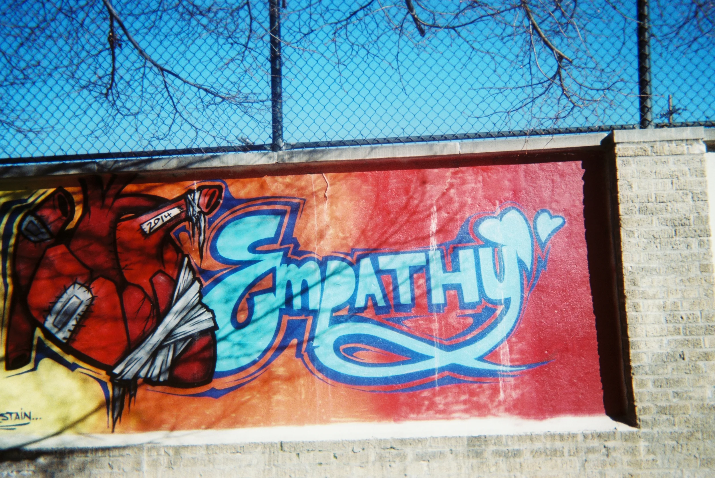 EMPATHY There is middle school across the street from the Cathedral in Denver, which I often pass in my walks. The concrete sections of the walls which separate the campus from the street have all been decorated with brightly-colored street art by past students and community members. This particular part has delighted me since I first walked by it. It speaks to me of the joy and connection with God we find in community, in fellow human beings crossing the differences which can separate us with love and compassion, and yes– empathy. -Tory Moir