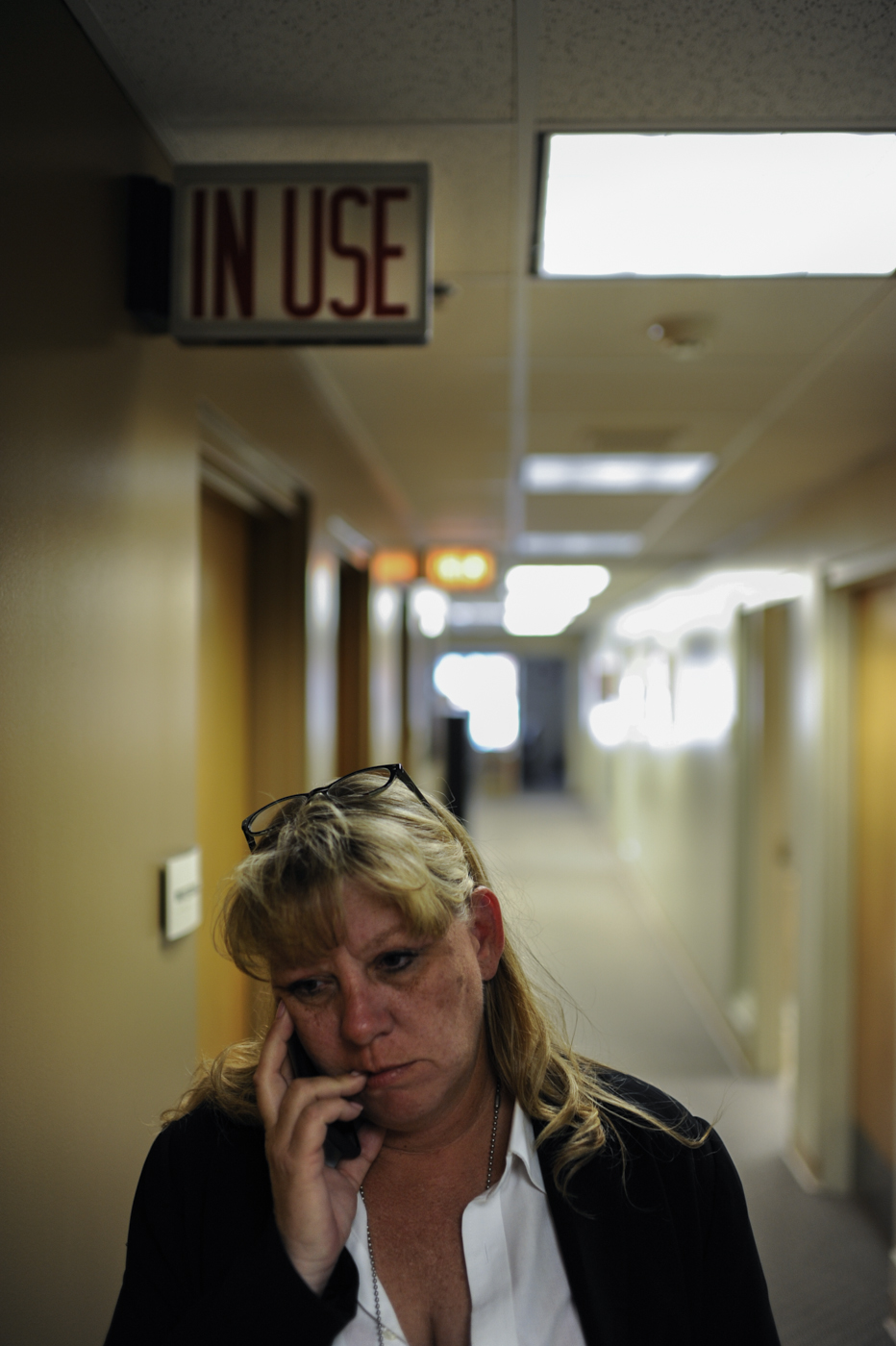  Passing the suspect interview rooms in the Platte County Sheriff’s station, detective Nancy Penrod calls home.    