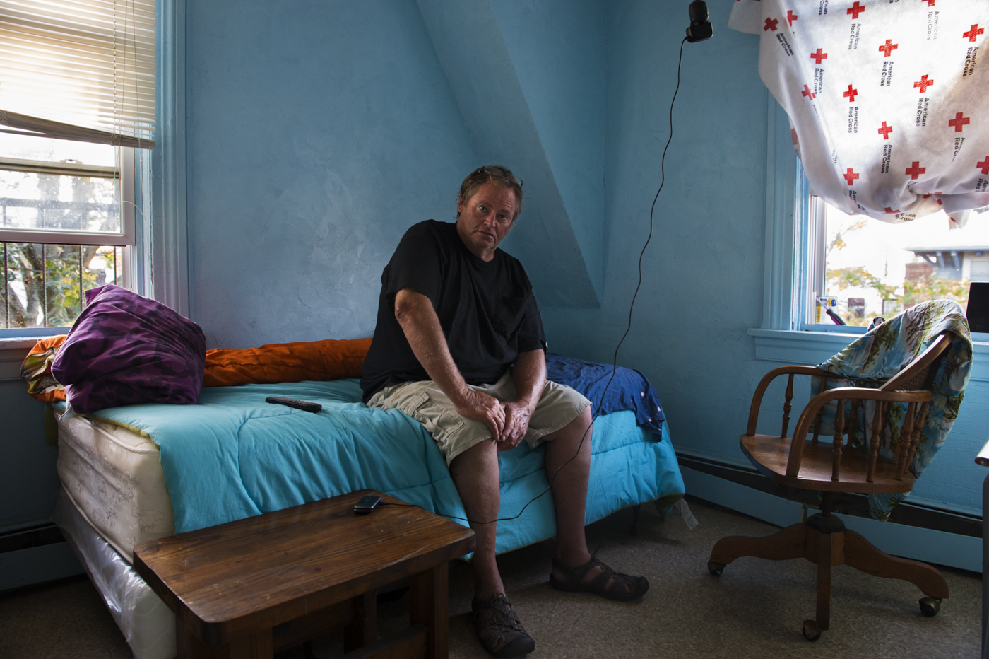 James Culleton relaxes on a late summer 2013 afternoon in his temporary home, a room in a single room occupancy residence in Rockaway Park. Despite the significant downgrade in accommodation, it is the first time since Superstorm Sandy hit that he can afford to have a place of his own. The SROs that still exist in Rockaway represent a bleaker side of the vibrant Rockaway beach community.