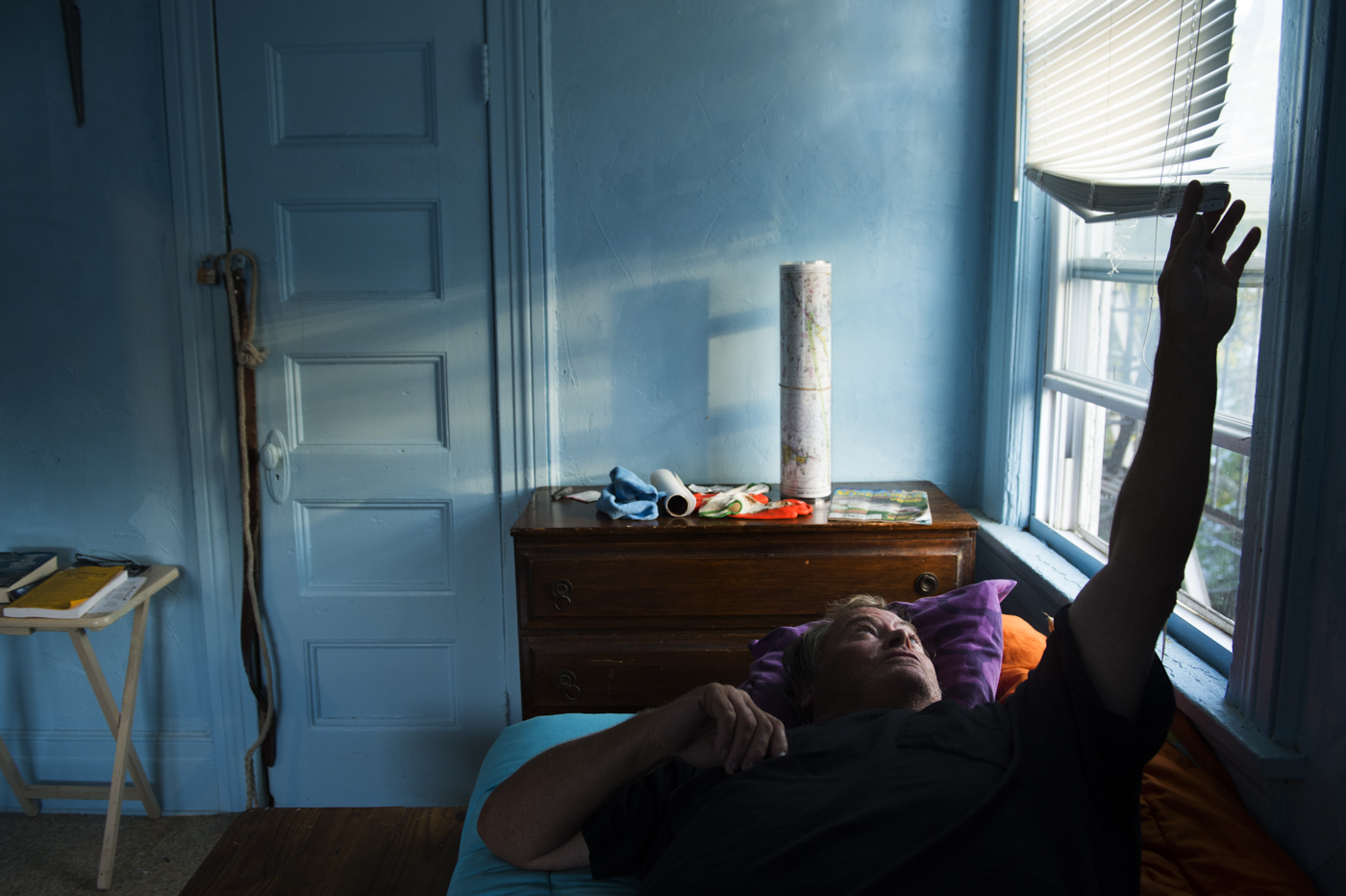  After a morning of fishing, James Culleton takes a moment to rest in his room at the single room occupancy residence in Rockaway Park. “Maybe the storm was a good thing. Maybe it’ll bring more fish. Maybe it got rid of a lot of debris out there. I d