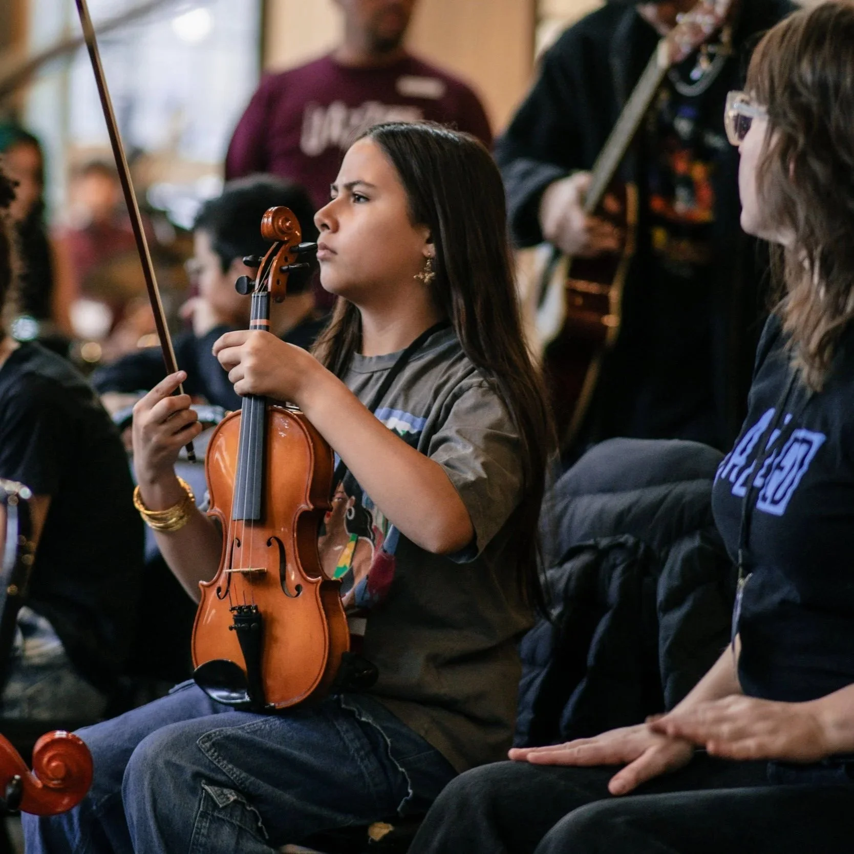Young JazzED student holding a violin in resting position