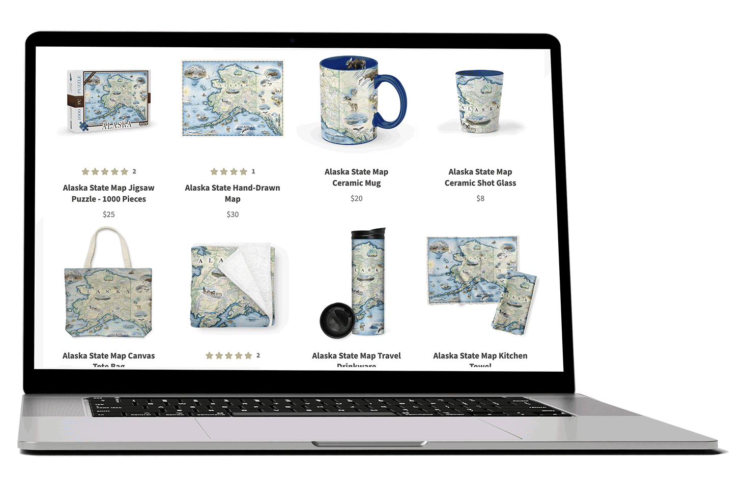 Laptop screen showing various Alaska state maps and products, including a puzzle, mug, shot glass, tote bag, towel, travel drinkware, and kitchen towel, all featuring a map design.