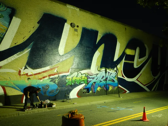 Artists working on the exterior mural.