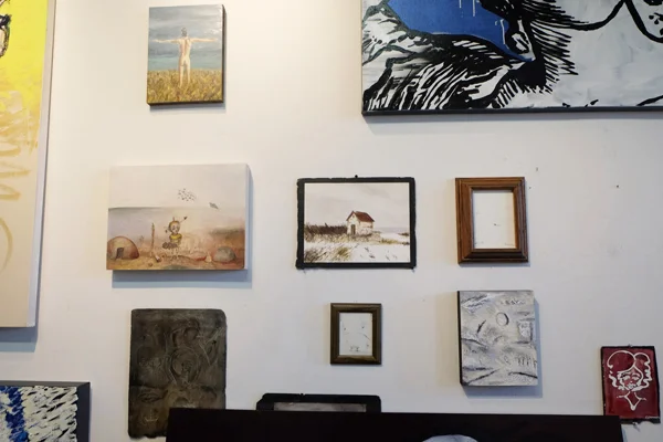 John proudly hangs some of son’s work as well.