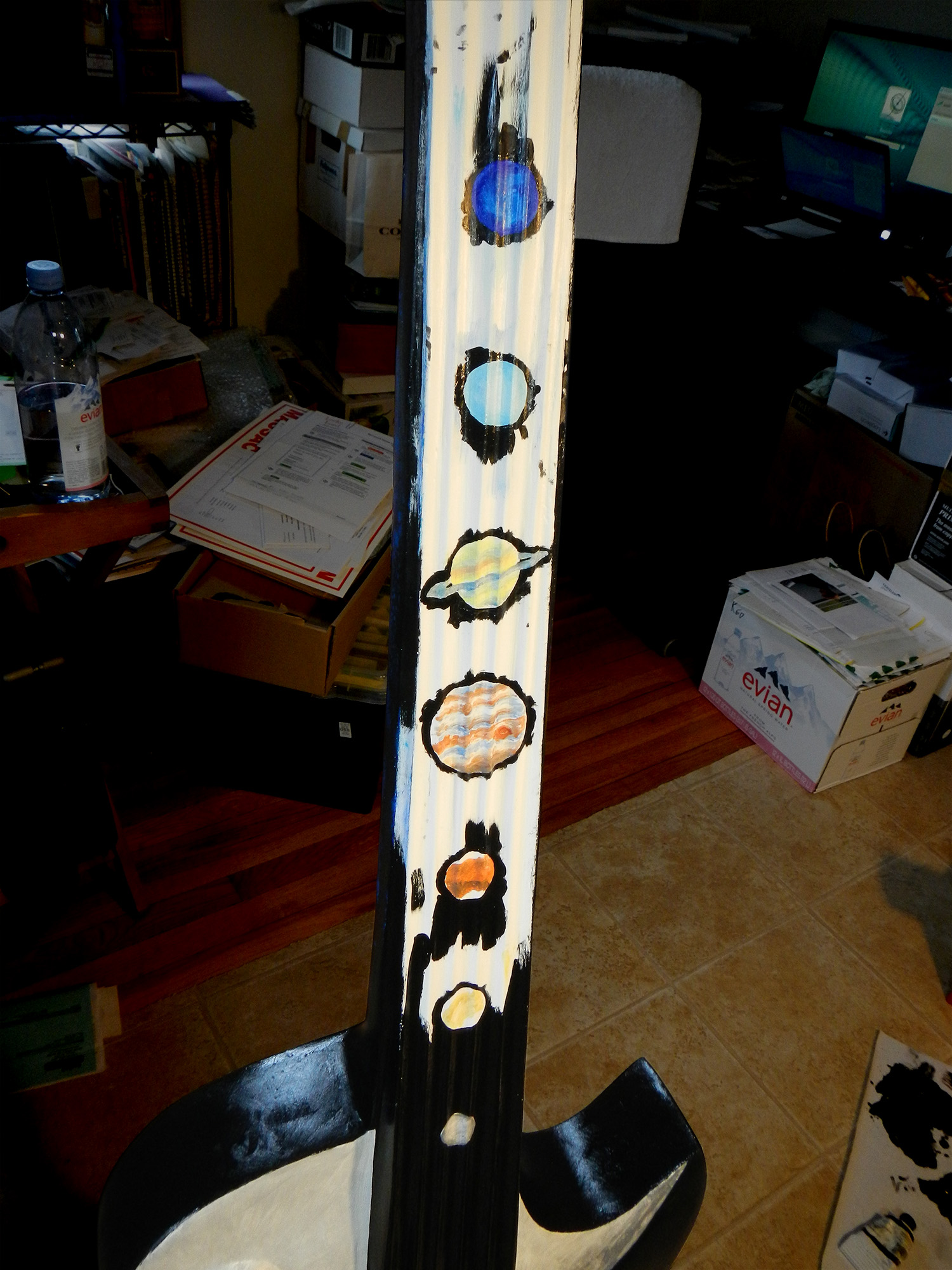 I edged in the planets on the neck and painted in the black.