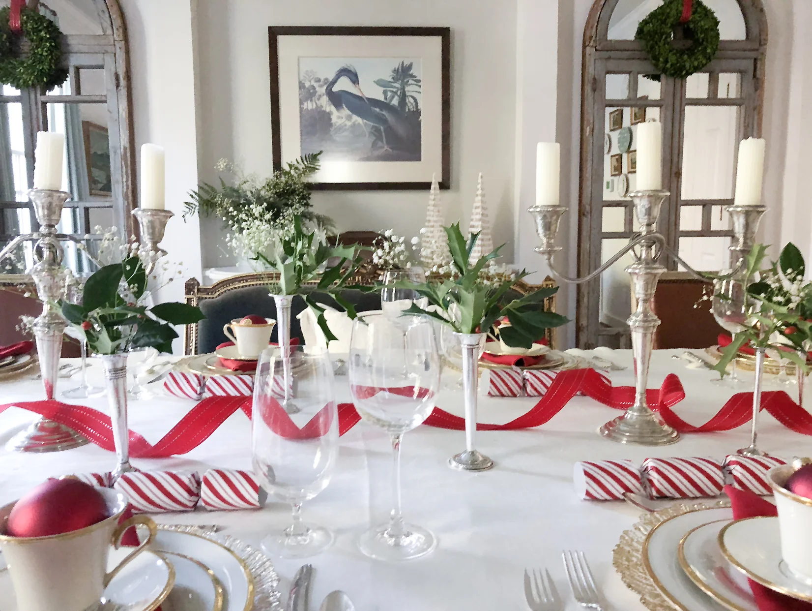 Finally, red linen napkins and a red ribbon tie the colors of the table together while giving a nod to our traditional southern style. The eye-catching shine of silver and gold, the pops of vivid red and green, and the combination of elements and accents both cherished and new: our table honors the past, celebrates the present, and heralds a bright new year.