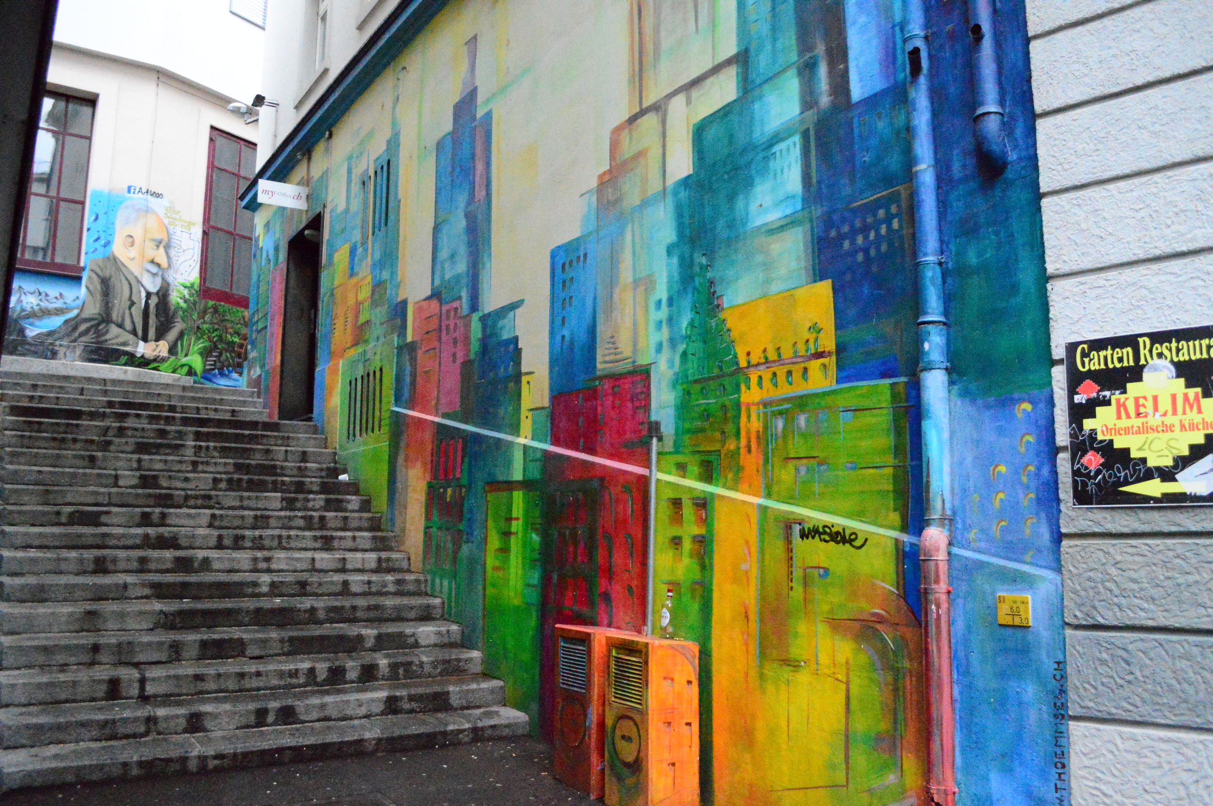  Street art isn't always grafitti. Sometimes it actually brights up a dark alley with real art. Welcome to Basel, Switzerland. This place is a giant mish-mash of different cultures, classes and overall vibes as it became an amalgamation of the French