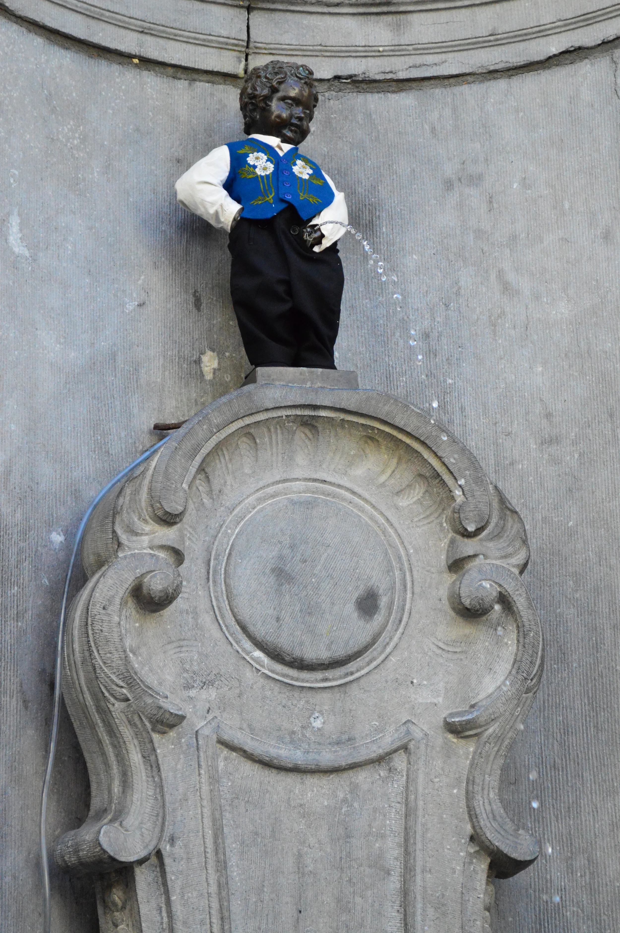  If you’ve ever stumbled upon pictures of Brussels, you’ve likely seen a shot of this little statue peeing either naked or in various costumes. Lovingly referred to by Belgians as Manneken Pis,&nbsp;so easily embodying the rebellious spirit of the ci