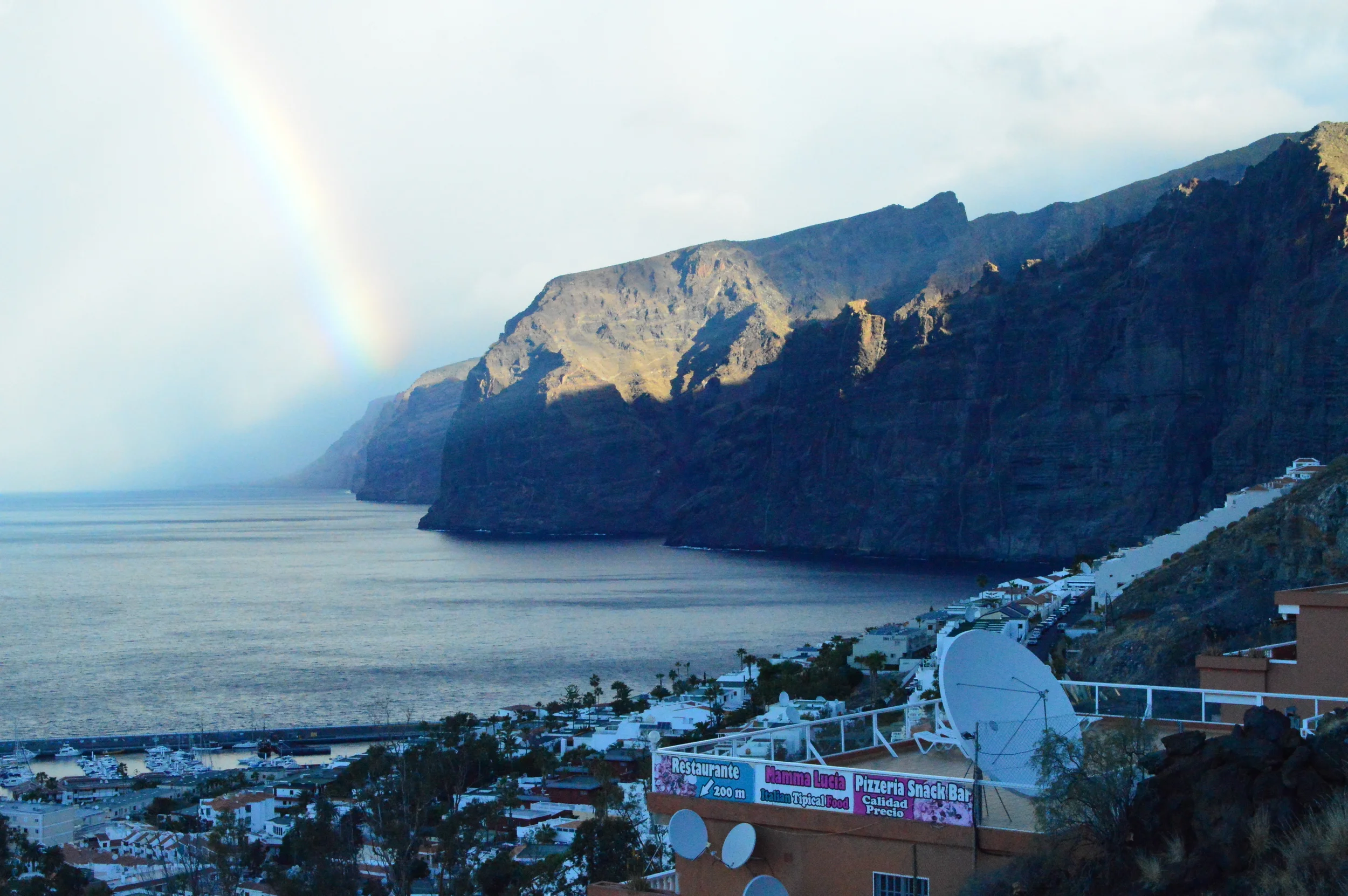  One of the best parts of my excursion to the west of Tenerife happened just as we embarked with a full shuttle and began our ascent along the western coastline; Los Gigantes stood below us with a perfectly-timed rainbow shimmering along its edges.  
