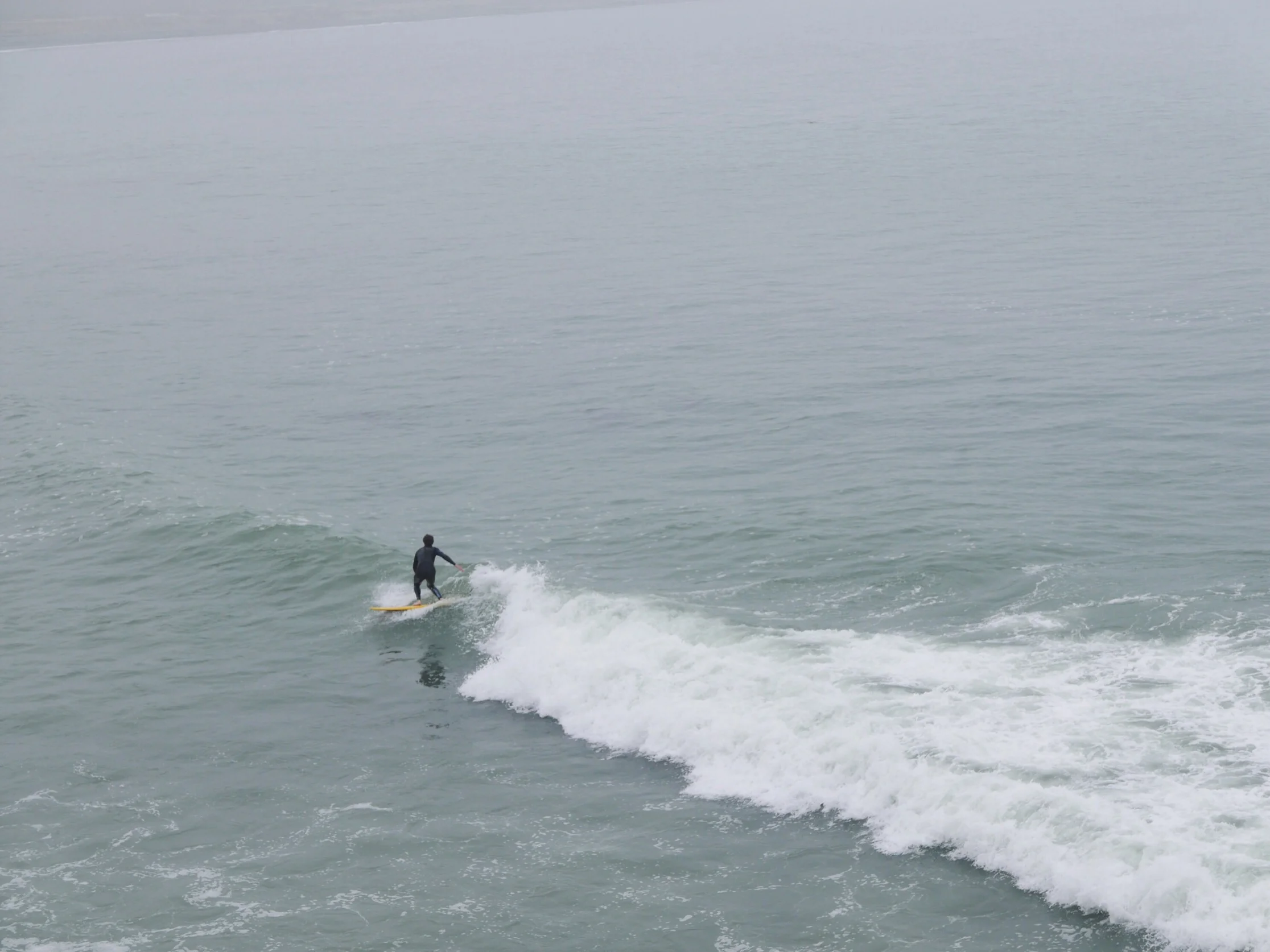 The waves got better and better throughout the morning, but the camerawoman grew tired of her perch on the bluff. :)