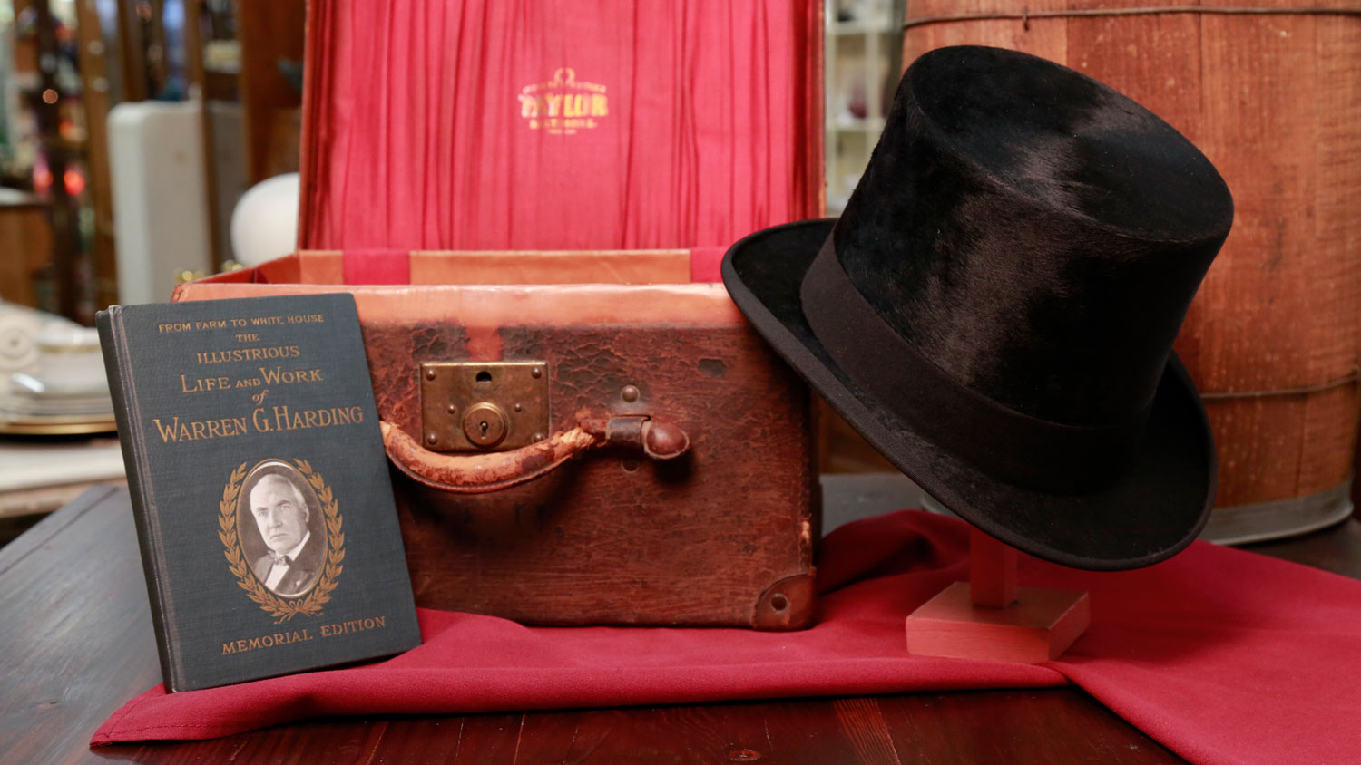  Black beaver top hat and hat box with initials WGH and a book  titled, From Farm to White House.  The Illustrious Life and Work of Warren G. Harding are shown. 