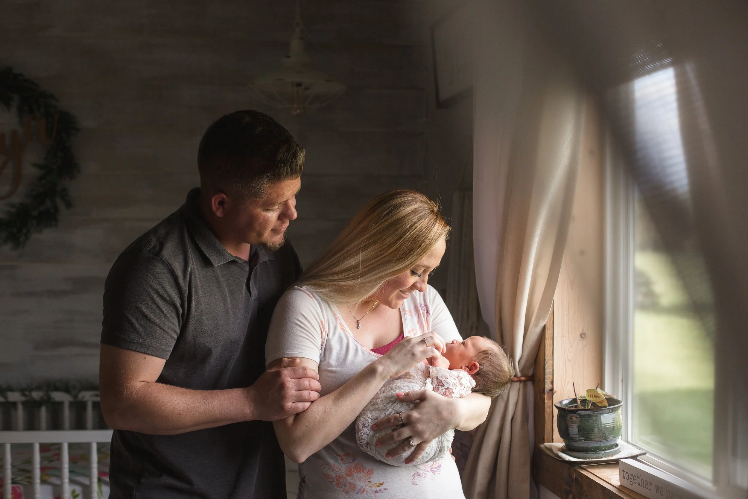 Newborn lifestyle parents admiring their sweet new baby