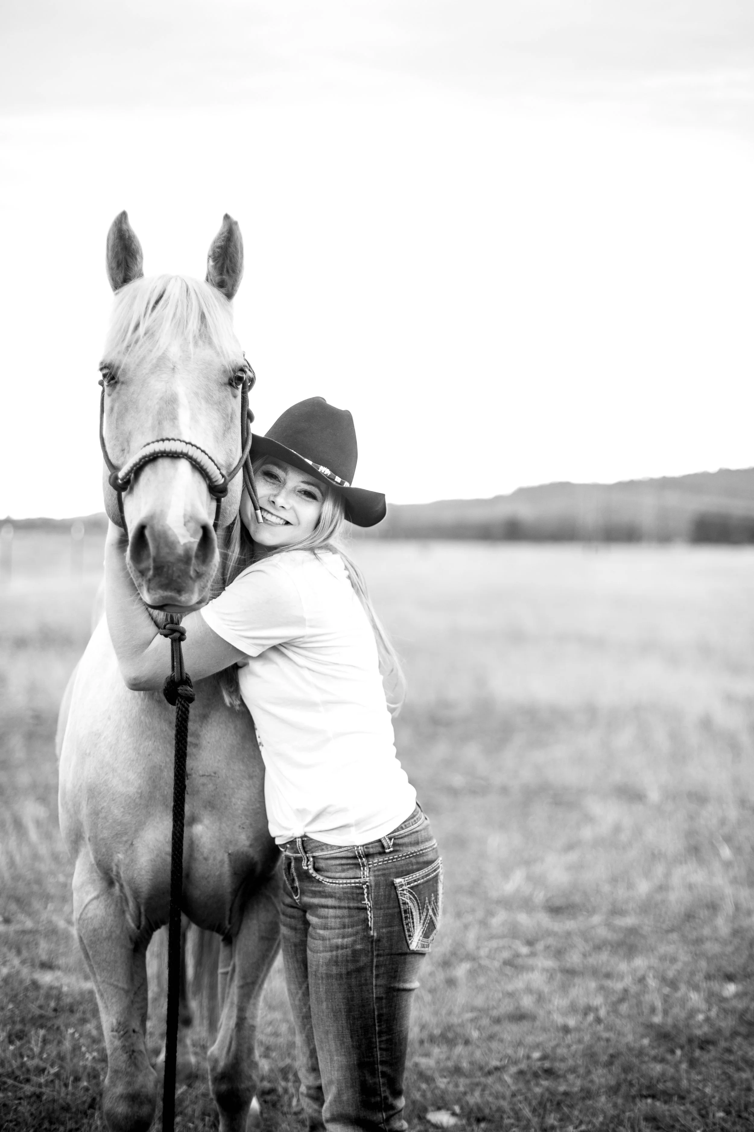 Senior photos in North Idaho featuring high school senior with horse in natural outdoor setting