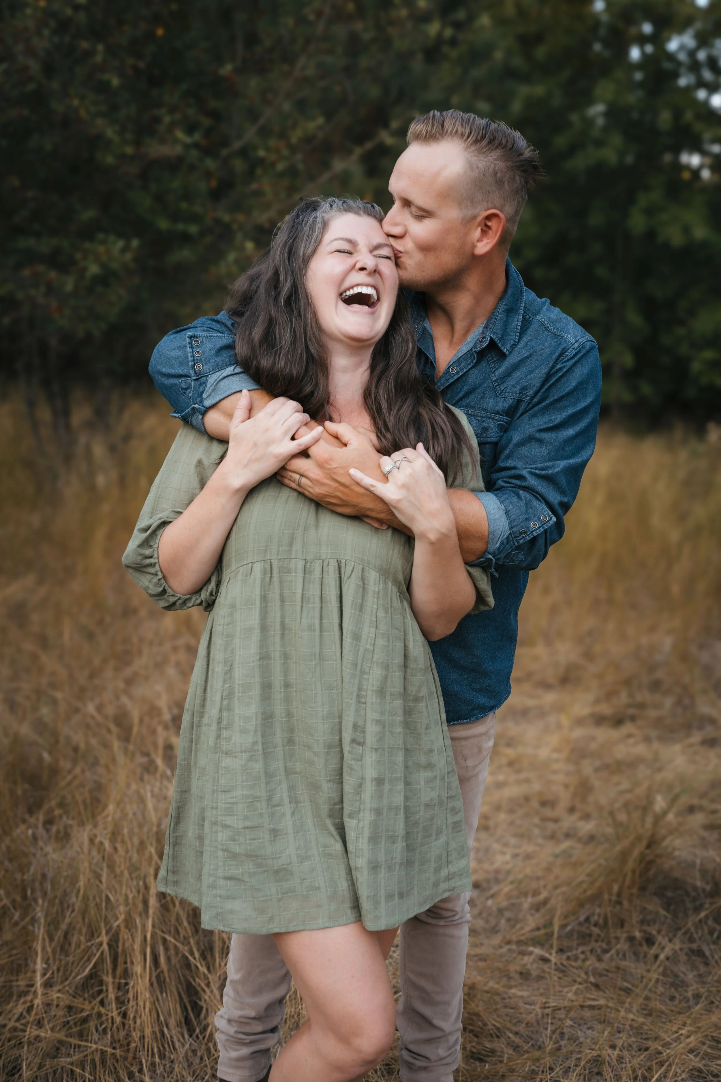 couple in love laughing in green dress summer session in coeur d alene idaho