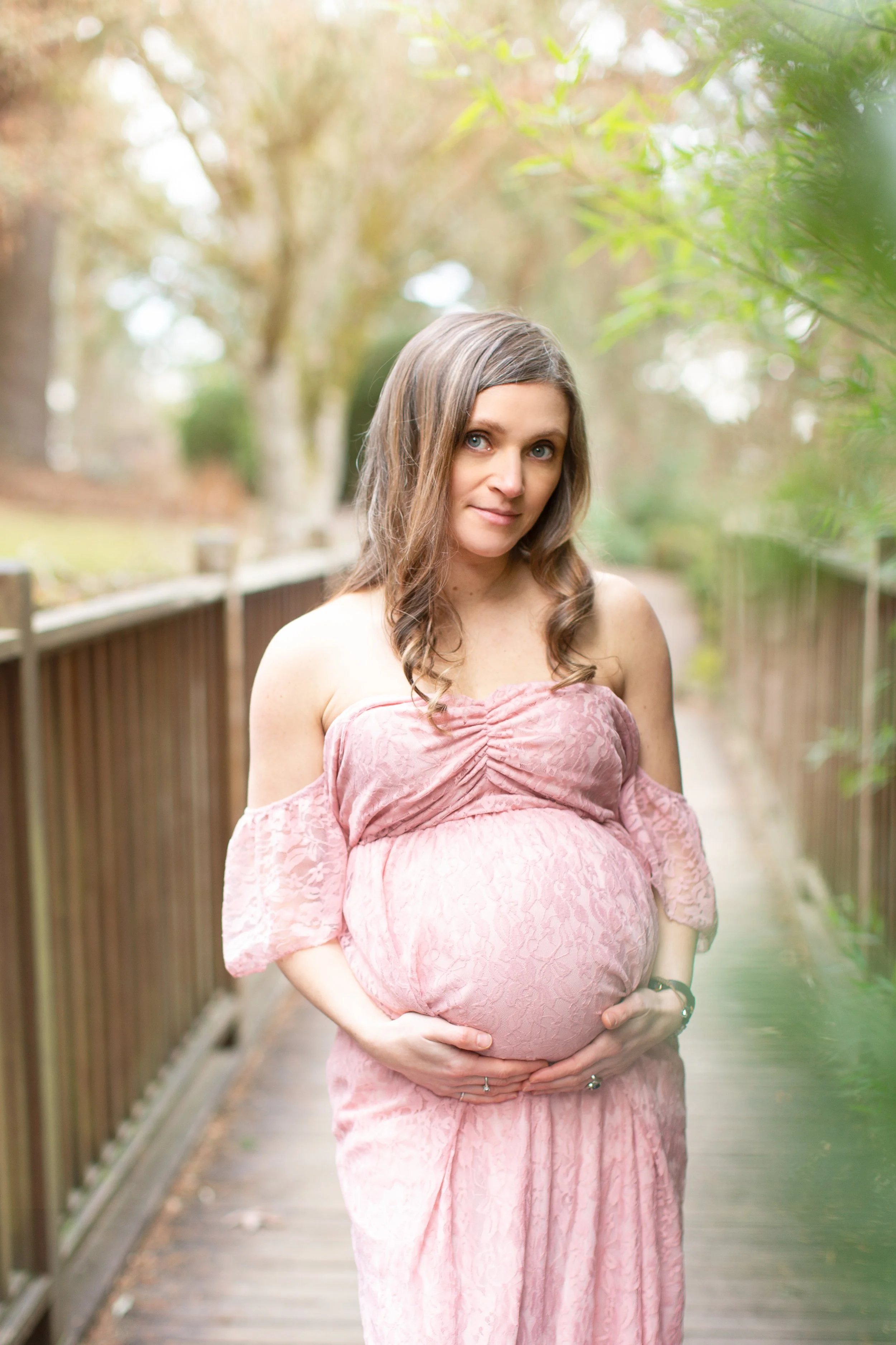 A soft outdoor maternity portrait capturing the quiet beauty and anticipation of pregnancy.