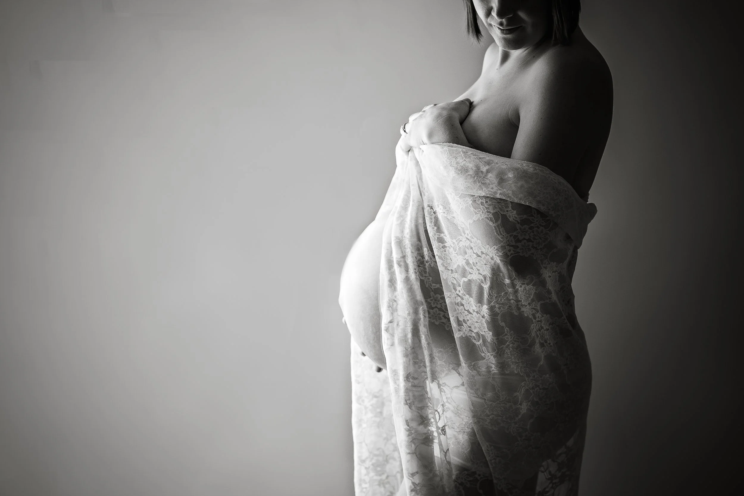 A timeless black and white maternity portrait highlighting the strength, grace, and natural curves of motherhood.