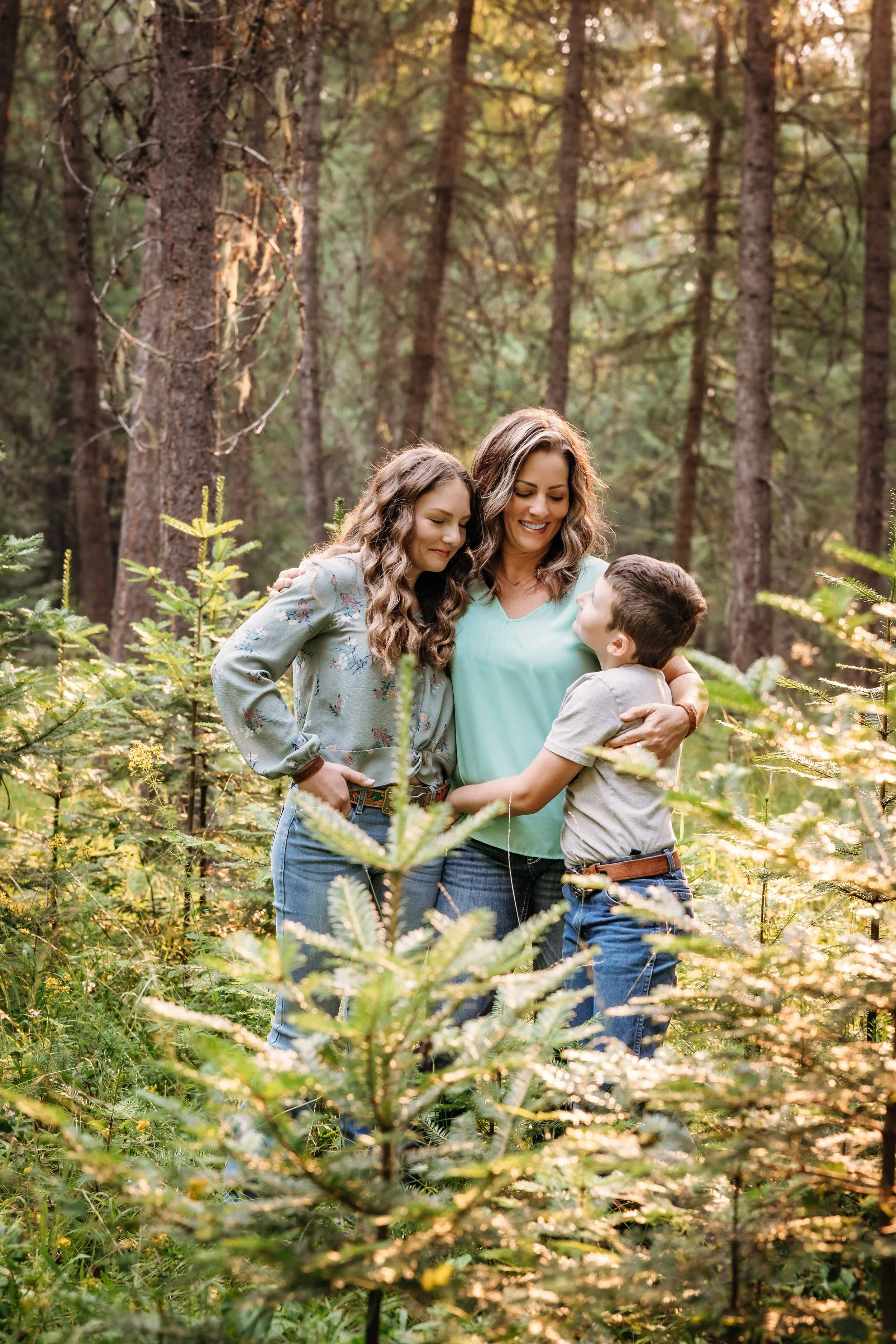 mother and children in forest at sunset in Athol, Idaho