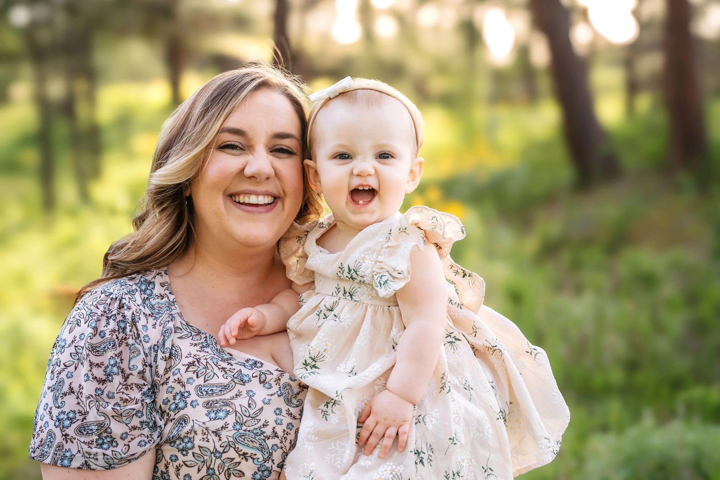 Parents holding toddler in golden light outdoor family photography