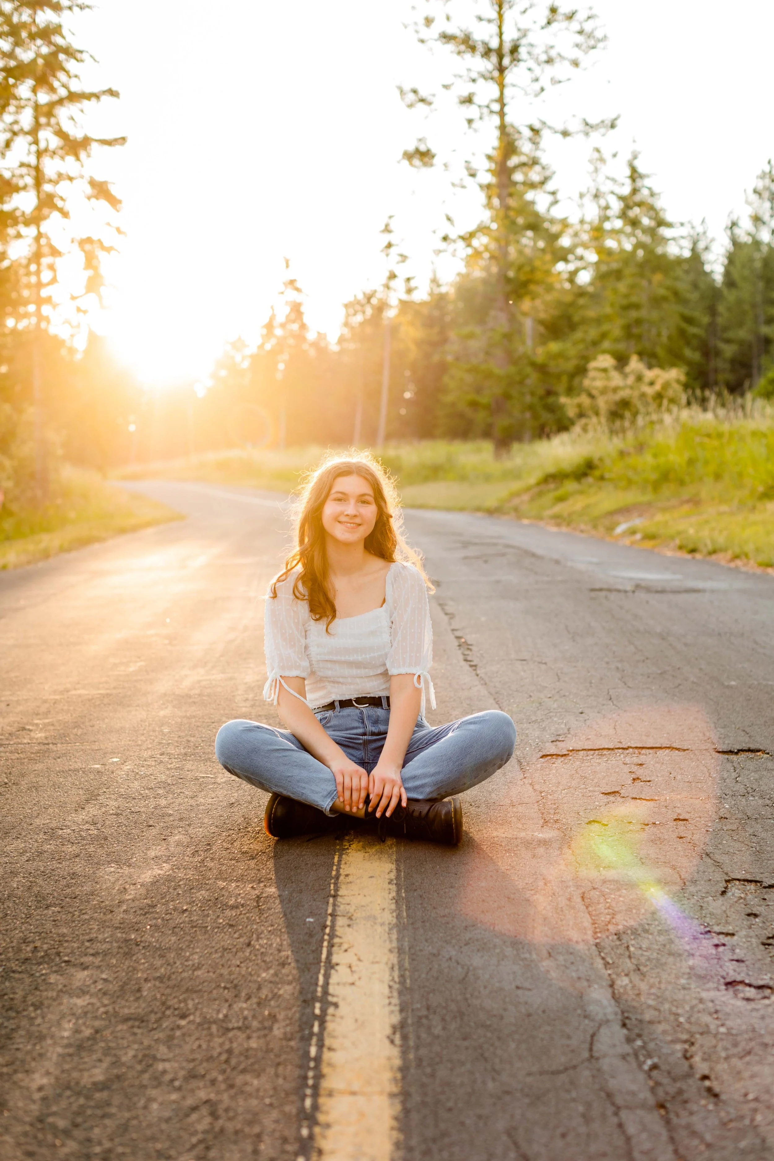 Outdoor senior photos in Coeur d’Alene featuring soft golden light and natural movement. Perfect inspiration for Class of 2026 seniors.