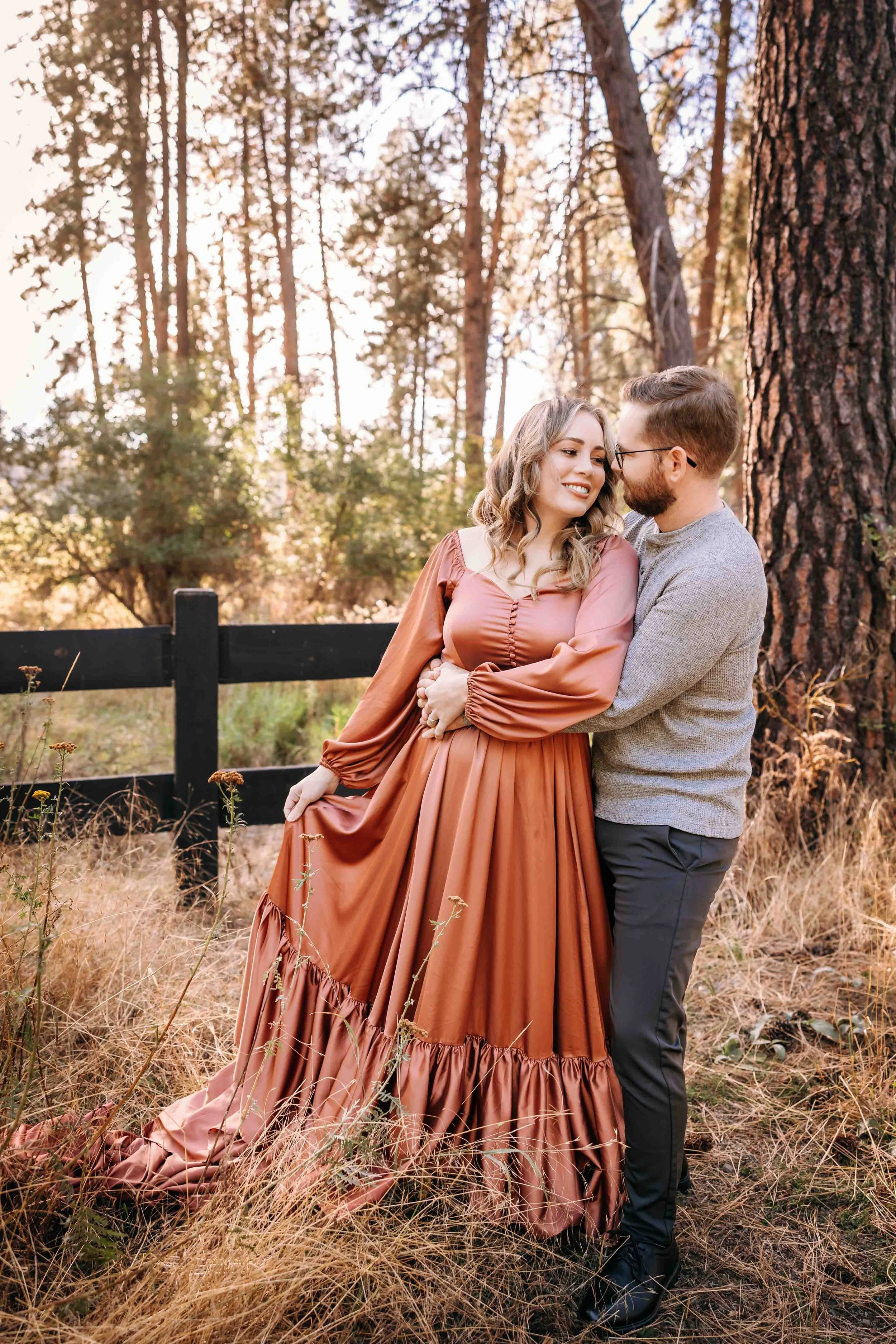 Couple portraits with beautiful flowing burnt orange dress at sunset in Hayden, Idaho