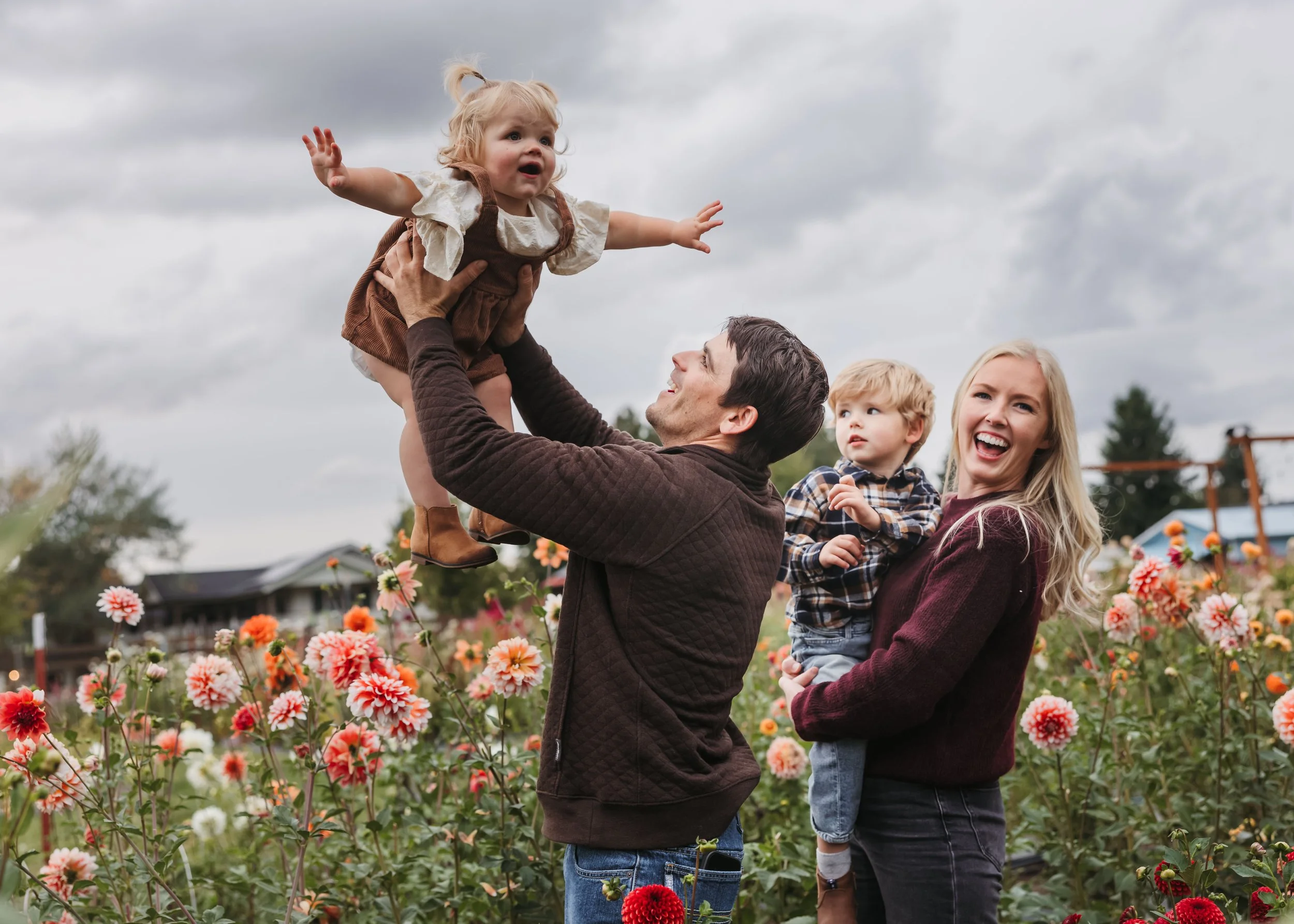 This is what connection looks like—unfiltered, honest, and real.Mother leaning in close to toddler during candid family session in floral garden setting